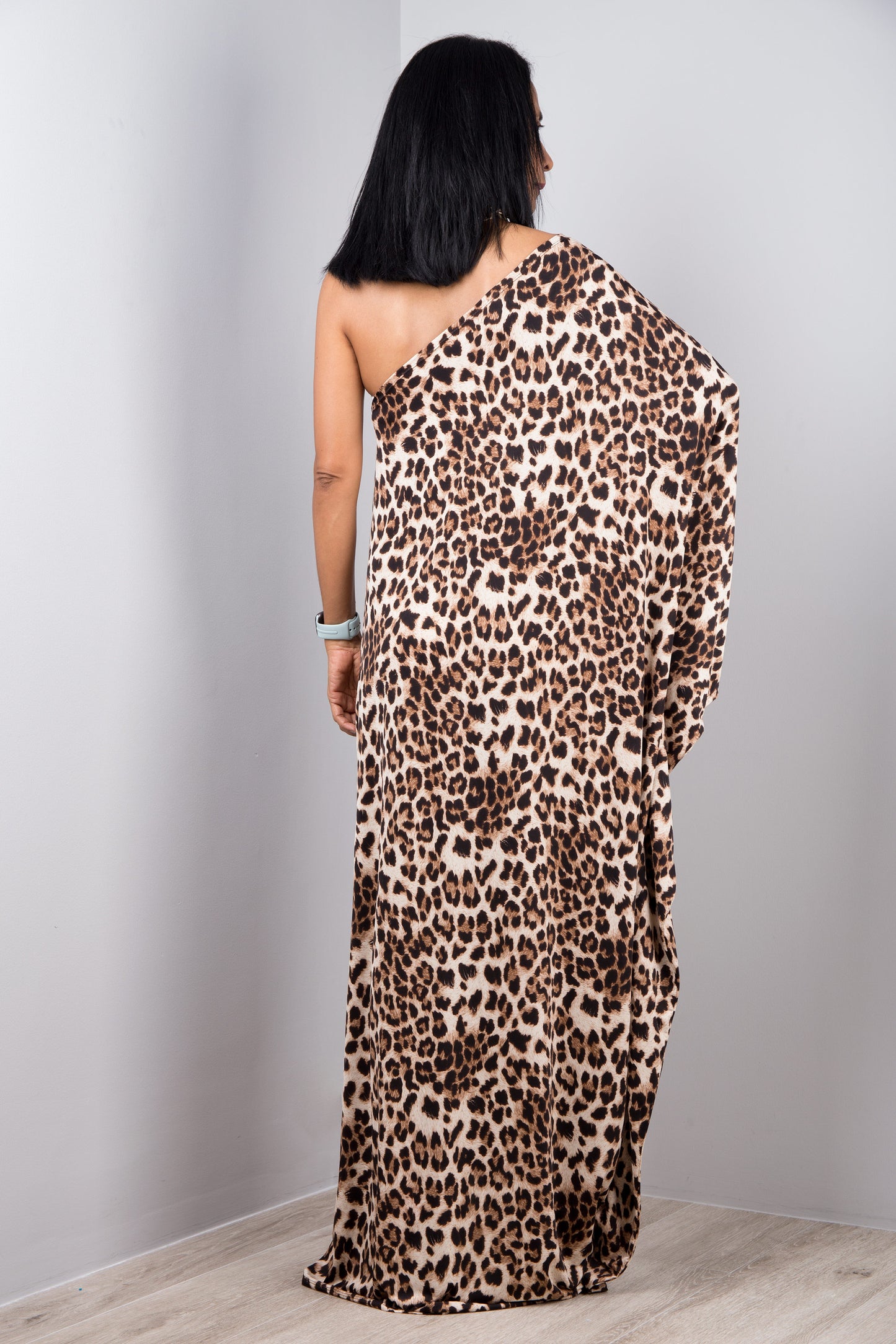 Handcrafted Nuichan one shoulder leopard dress featuring a cheetah print pattern in natural brown tones. Made with sustainable, handwoven fabric, this boho dress combines artisanal craftsmanship with a modern asymmetrical design for a unique, eco-friendly look.