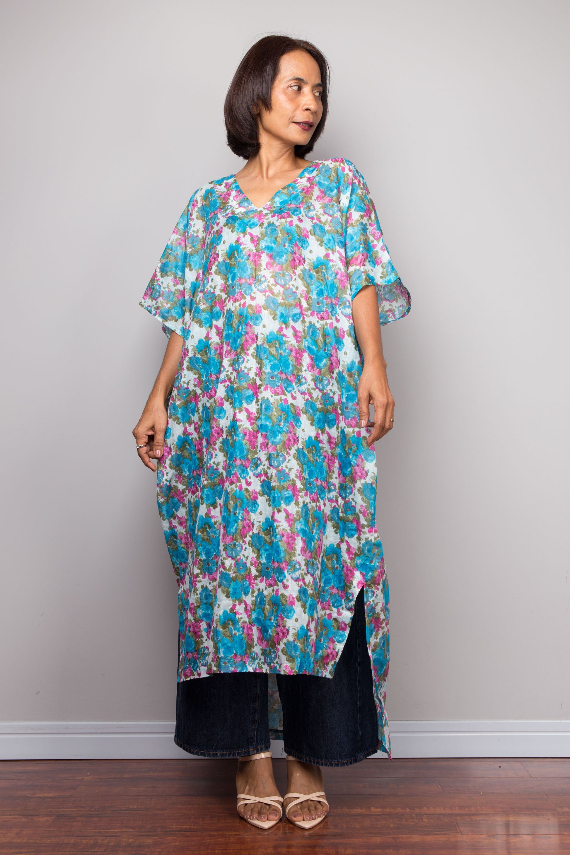 Petite Woman wearing a floral cotton kaftan midi dress against a plain background