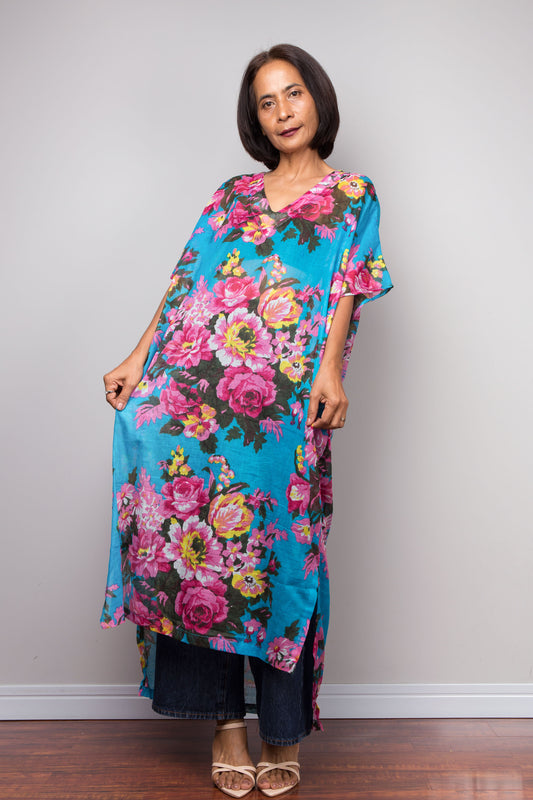 Petite Woman wearing a colorful floral caftan dress against a plain background
