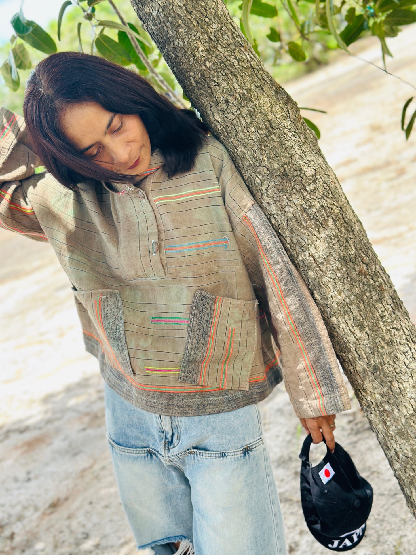 Handwoven hemp pullover hoodie, kangaroo pockets, stylish women’s sustainable wear.