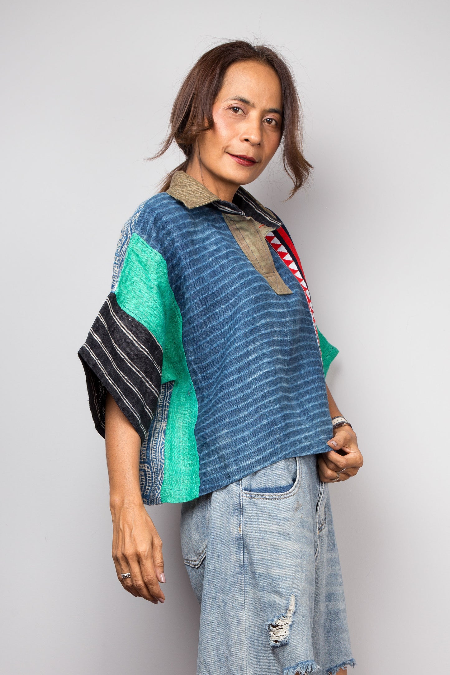 Patchwork polo shirt pullover top made from various handwoven hemp fabrics. Side view over sized hemp top