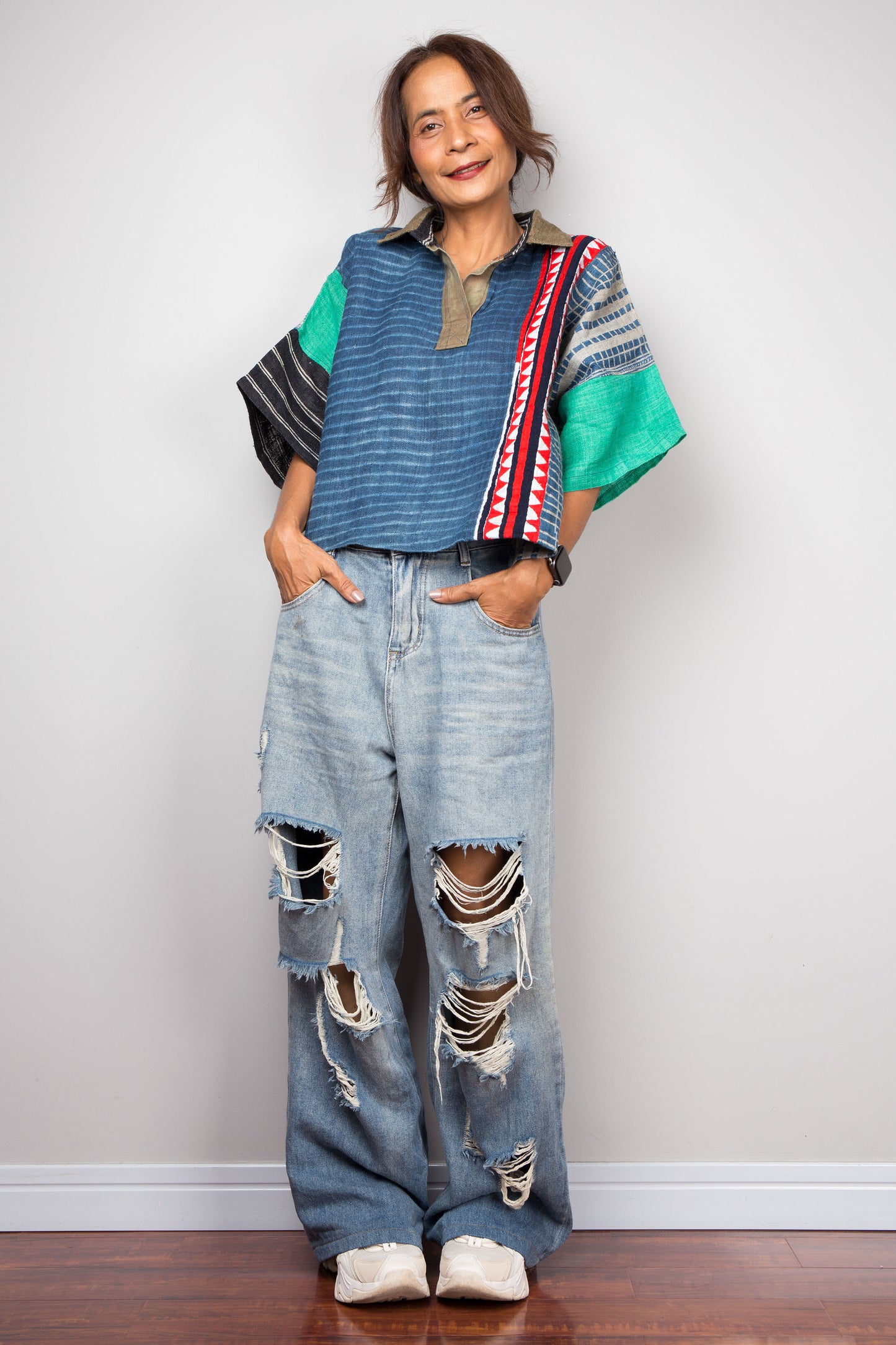 Patchwork polo shirt pullover top made from various handwoven hemp fabrics. Blue frontal part with brown collar and a vertical red line running from the shoulder to the hem