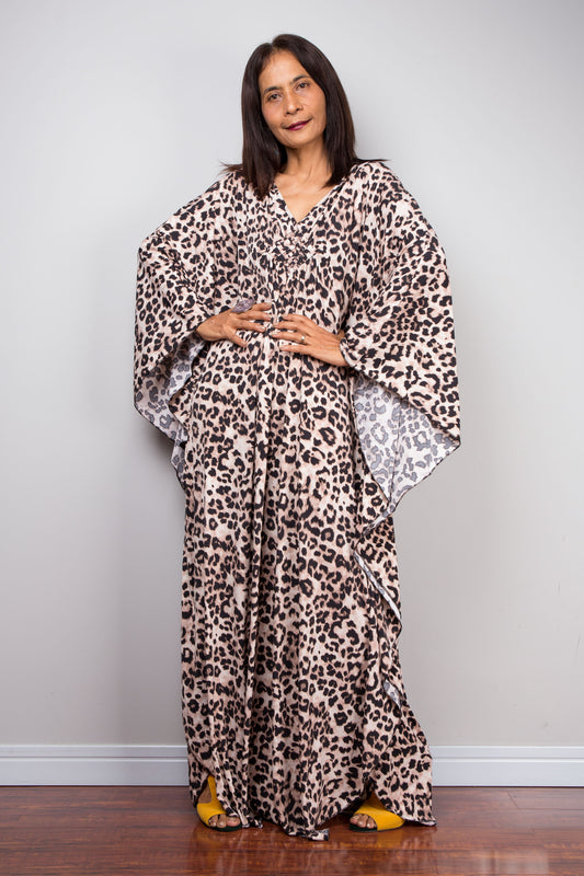 Leopard Print Kaftan Dress with Diamond Chest Detail - Full View
Stunning leopard print kaftan dress made from ITY polyester, featuring a loose boho silhouette with three-quarter sleeves and full length. The deep V-neckline showcases a diamond-shaped embroidery detail at the chest, complemented by side slits for a flowing fit, perfect for tropical beach days or summer festivals.