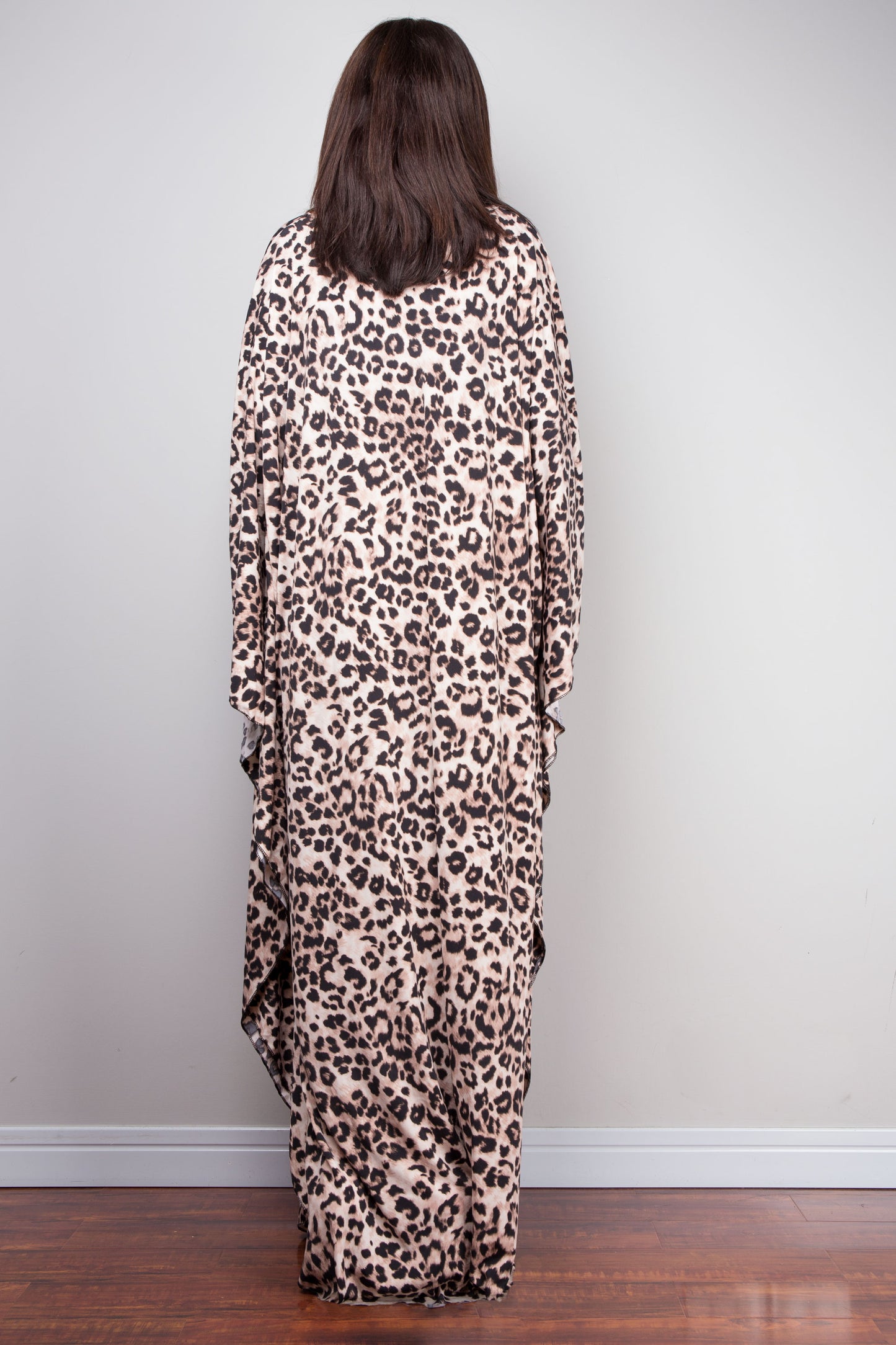 Boho-chic leopard print kaftan dress made from ITY polyestr. The dress’s deep V-neckline with a diamond-shaped detail, three-quarter sleeves, and full length make it a perfect choice for tropical summer fashion.