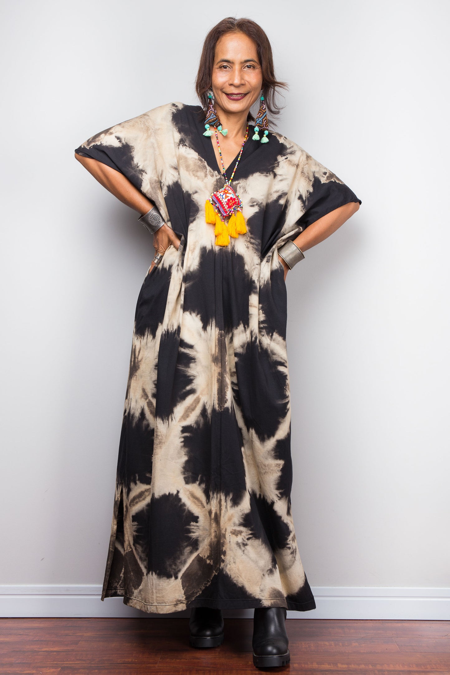 Woman wearing a Nuichan reverse tie-dye dress with a plain background