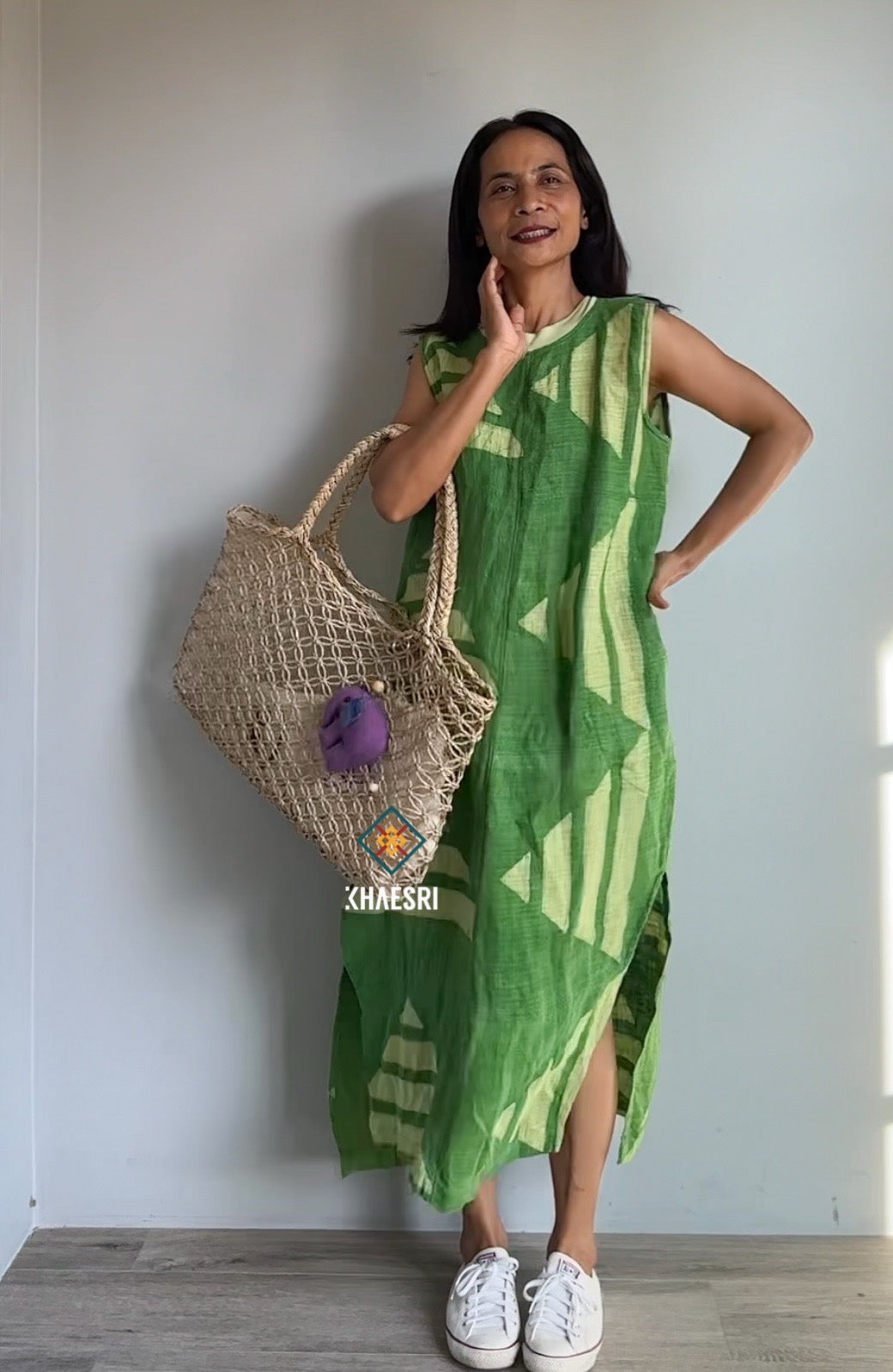 Nuichan sleeveless kaftan dress made from handwoven hemp, showcasing a green geometric design with white accents. This sustainable boho dress, photographed against a minimalist backdrop, offers an eco-conscious fashion choice.