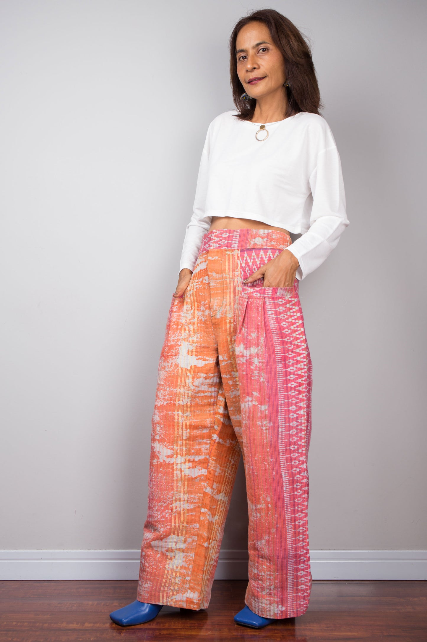 Discover Nuichan's handwoven, natural hemp pants with a bold pink and orange tie-dye design, blending traditional craftsmanship with modern style.