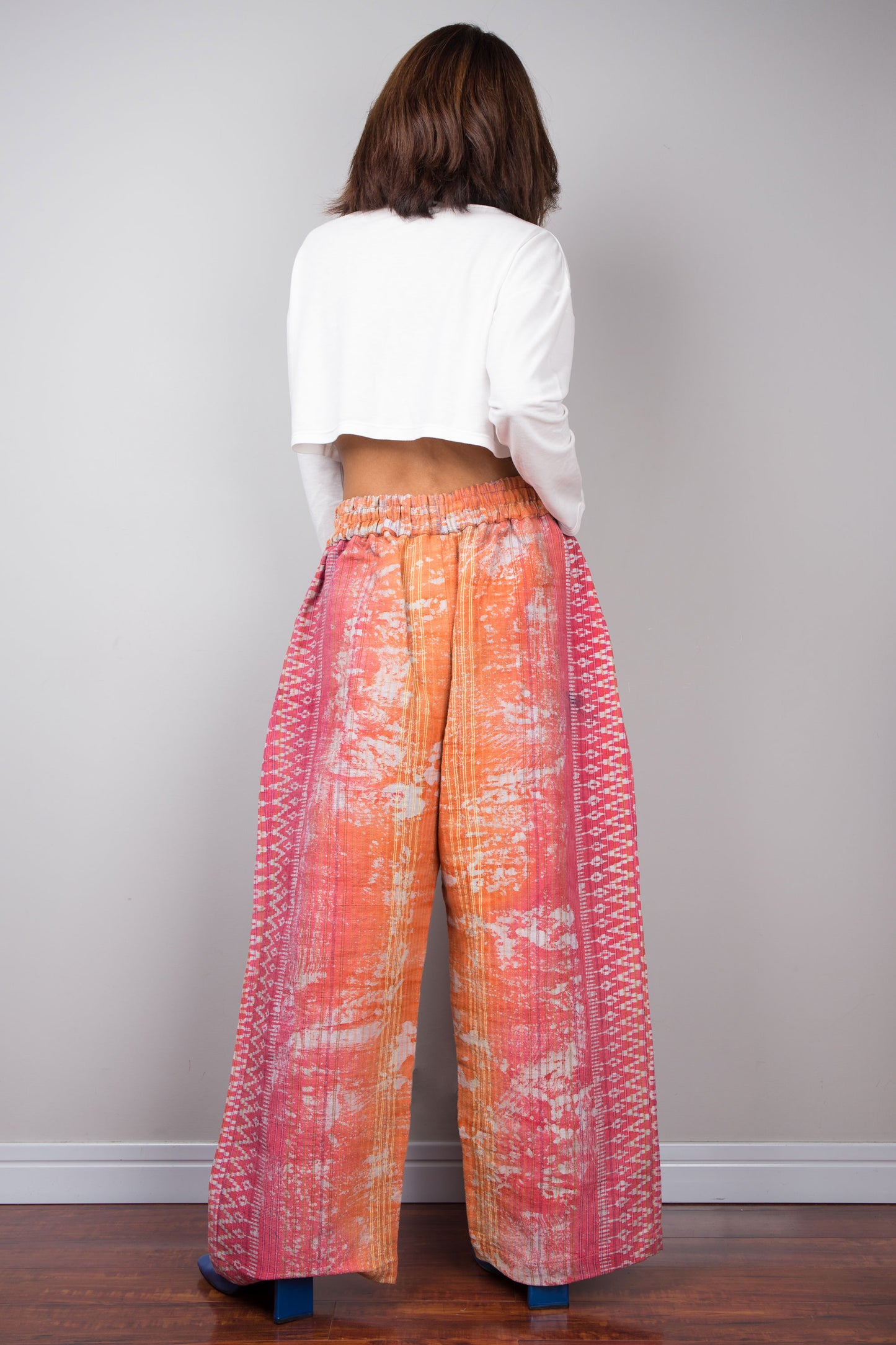 Embrace sustainable fashion with Nuichan's vibrant orange and pink tie-dye hemp pants, designed for both style and environmental consciousness.