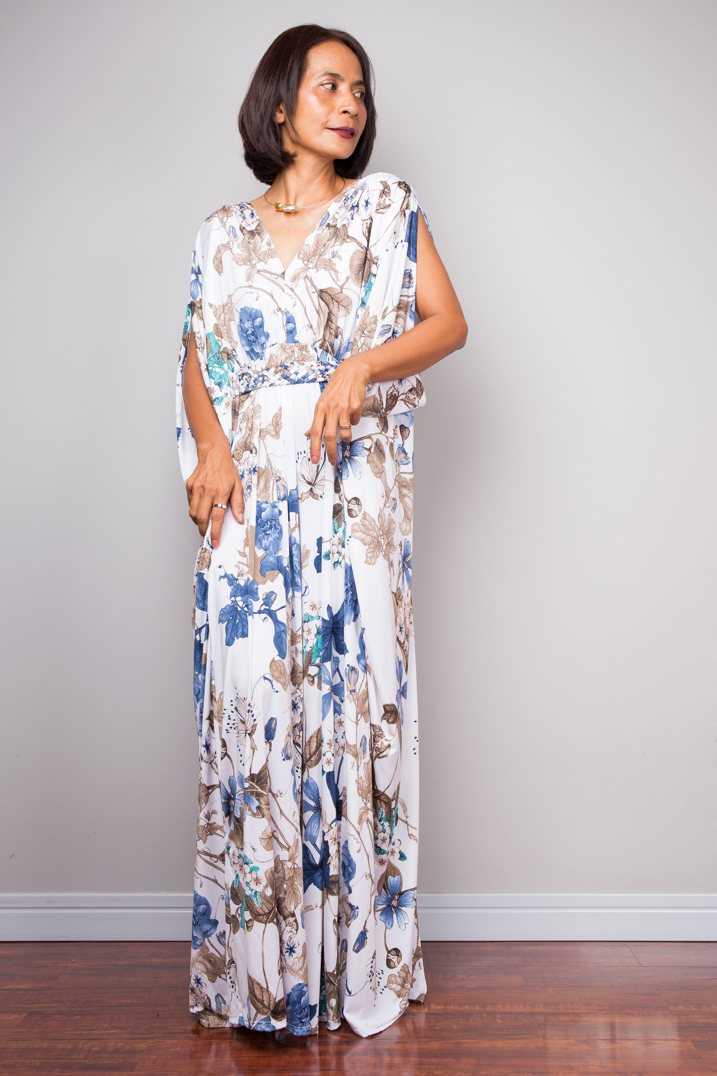 Resort-style white floral caftan with adjustable waist tie.
