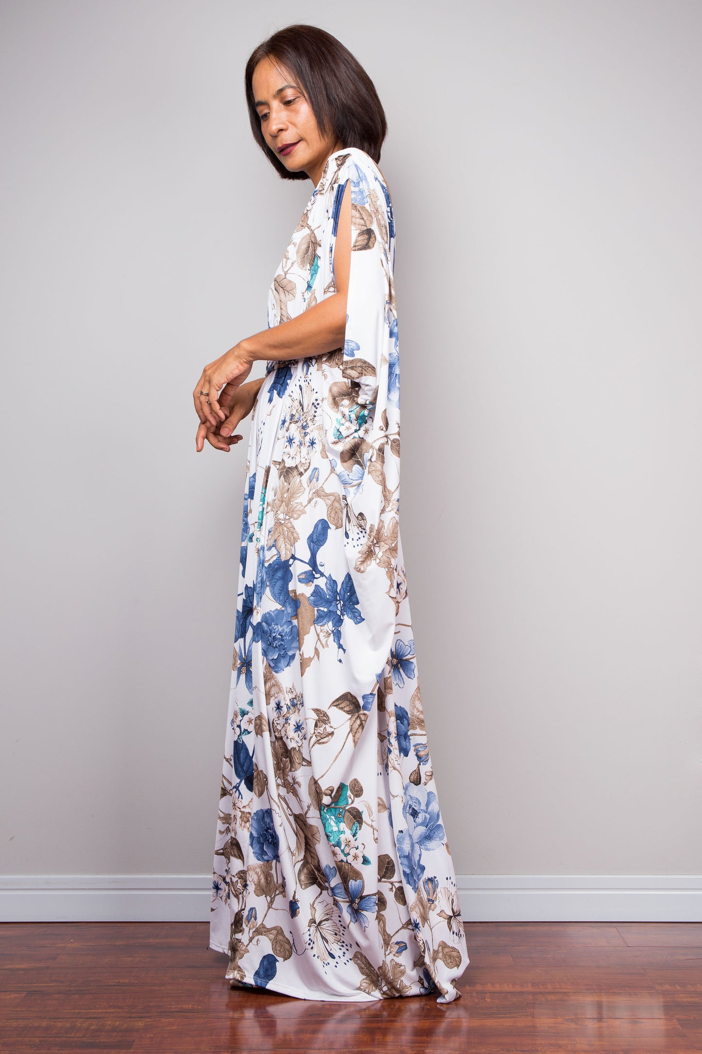 Bohemian-inspired floral print maxi dress with wide draped sleeves.