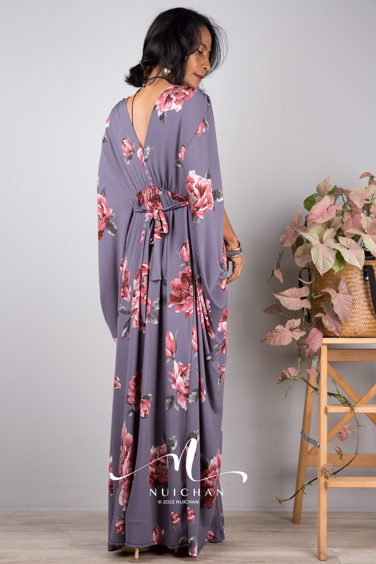 Floral print kaftan by Nuichan. Model wearing grey caftan with flower print