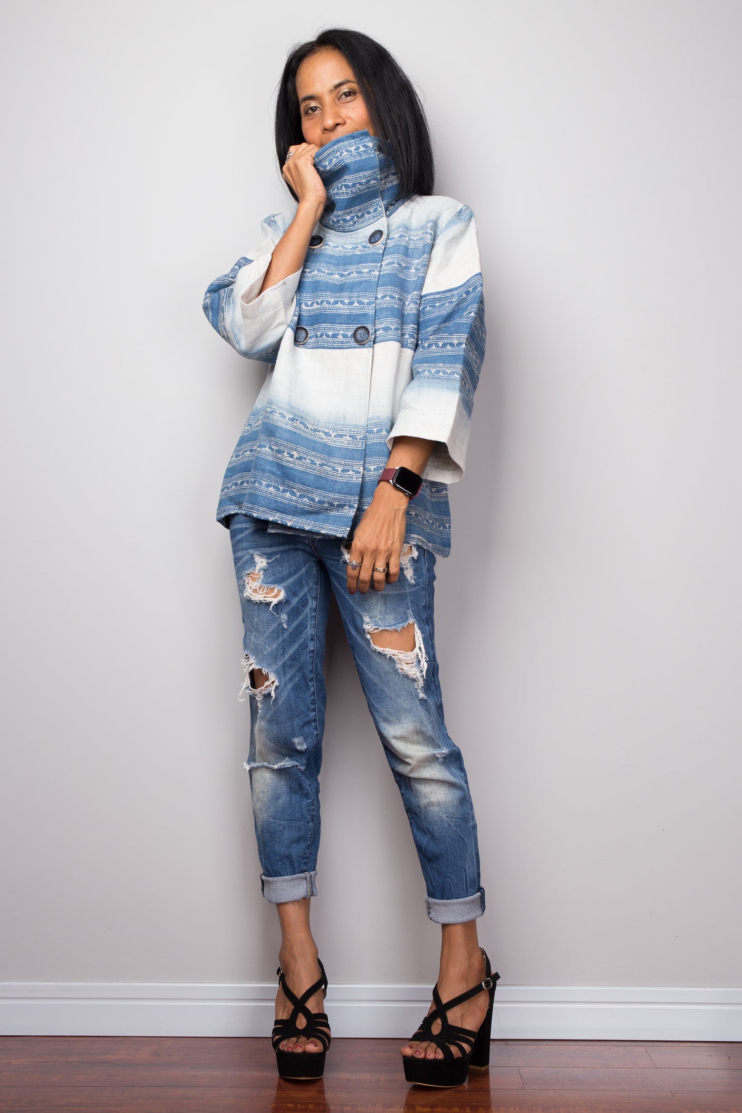 Model styling a boho hemp jacket with distressed denim and platform sandals
