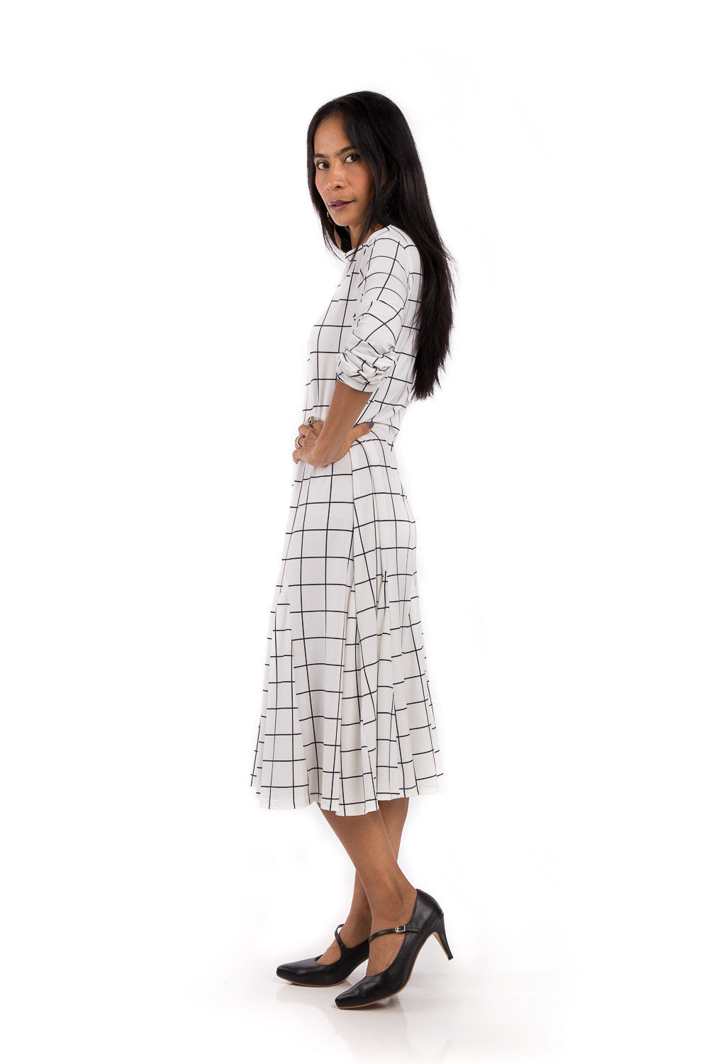 Knee length dress. White dress with black square print. Modest neckline and long sleeves. Tube dress with pleated bottom part by Nuichan.