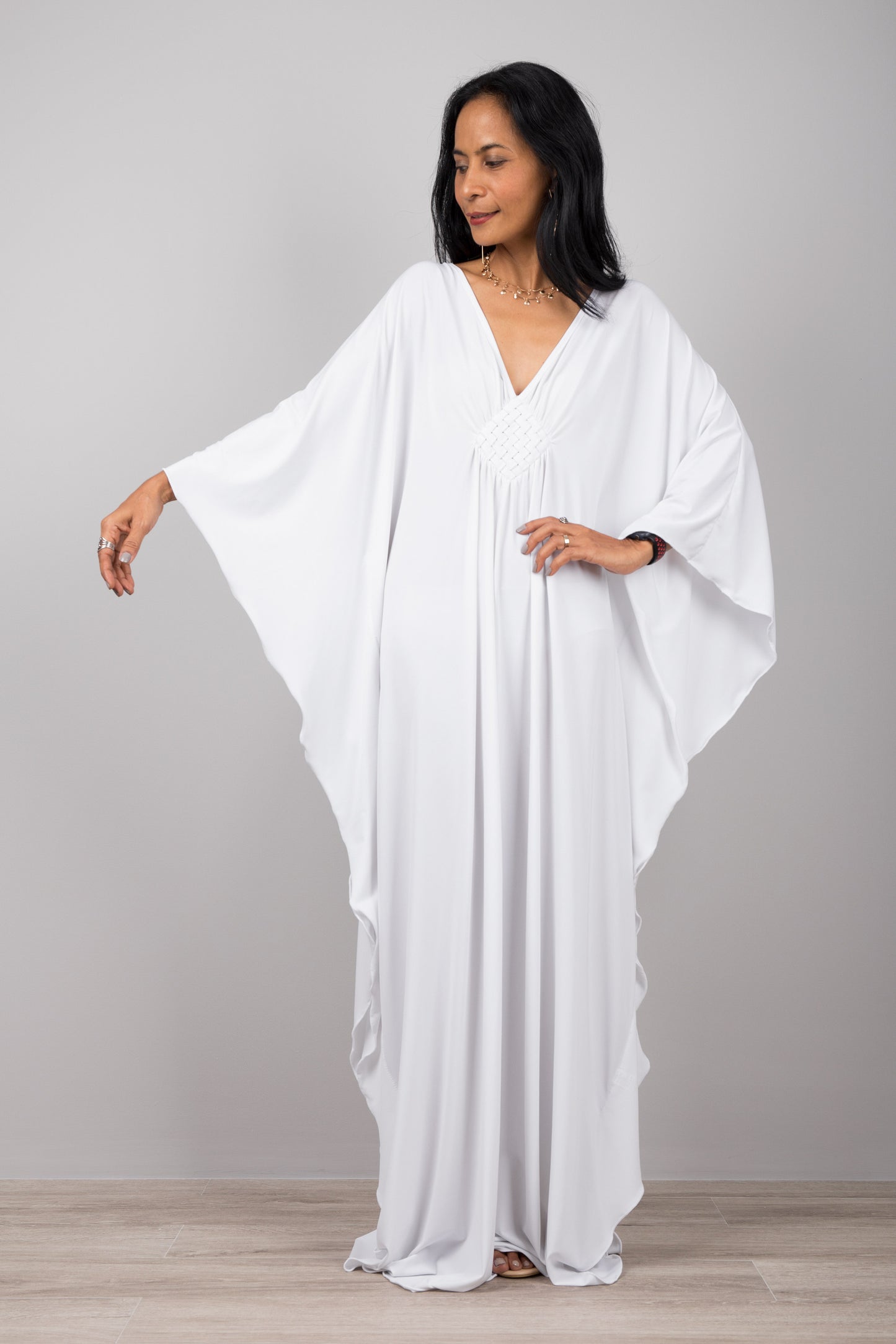 White kaftan dress with plunging neckline. Buy your timeless kaftans online from Nuichan. Express worldwide delivery via DHL.