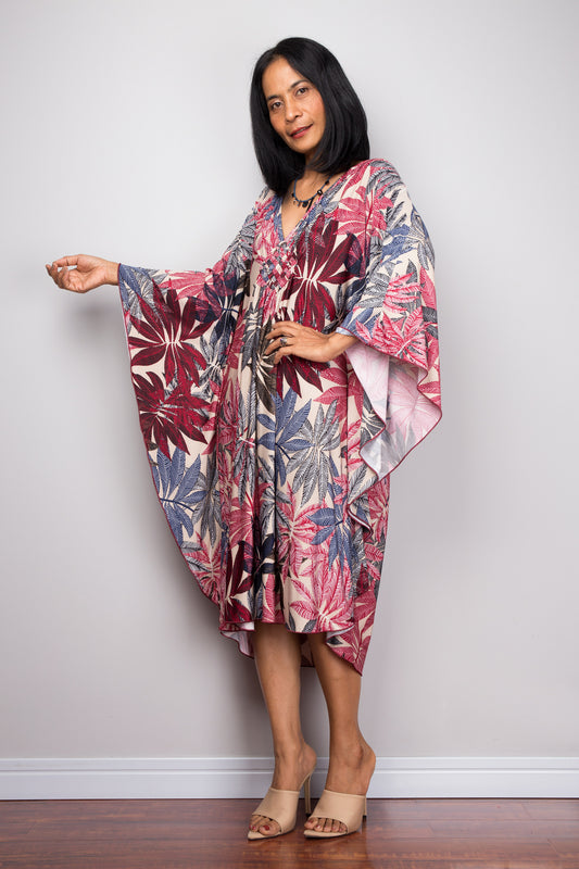 Tropical palm leaf kaftan dress in cream with pink and red floral pattern, spandex kaftan UK, wide sleeves, ideal for women’s boho summer style.