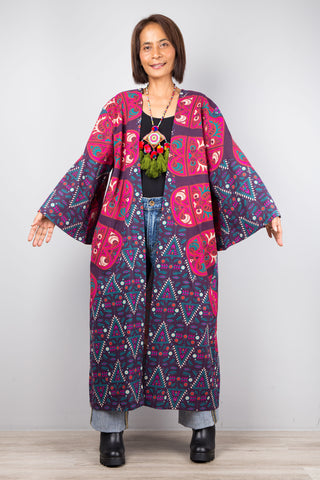 Long open front cardigan with pockets featuring a big mandala print on the back.  Purple and dark pink color tones.