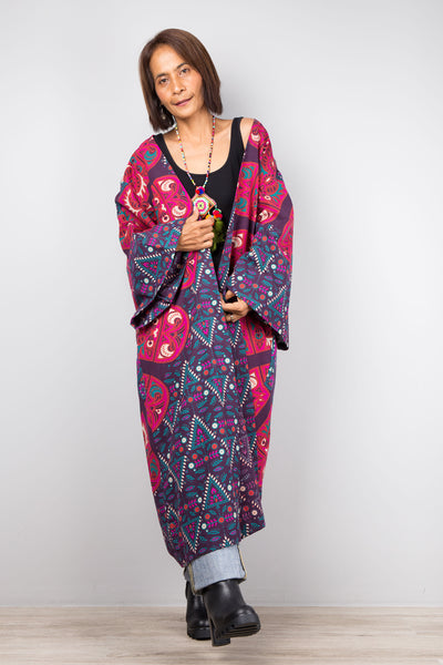 Long open front cardigan with pockets featuring a big mandala print on the back.  Purple and dark pink color tones.