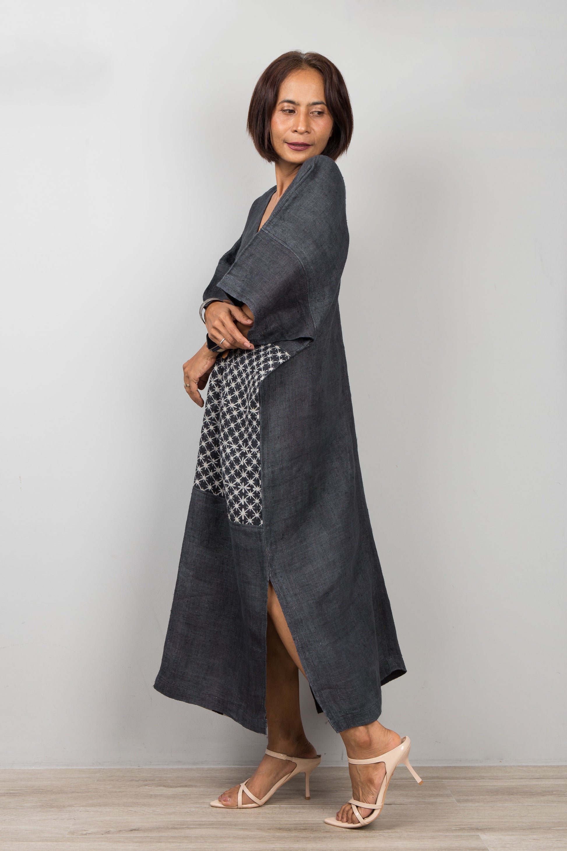 Woman wearing a long black patchwork hemp dress