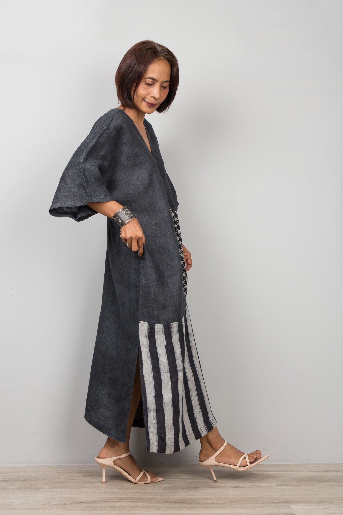 Woman wearing a black patchwork hemp caftan dress for petite women