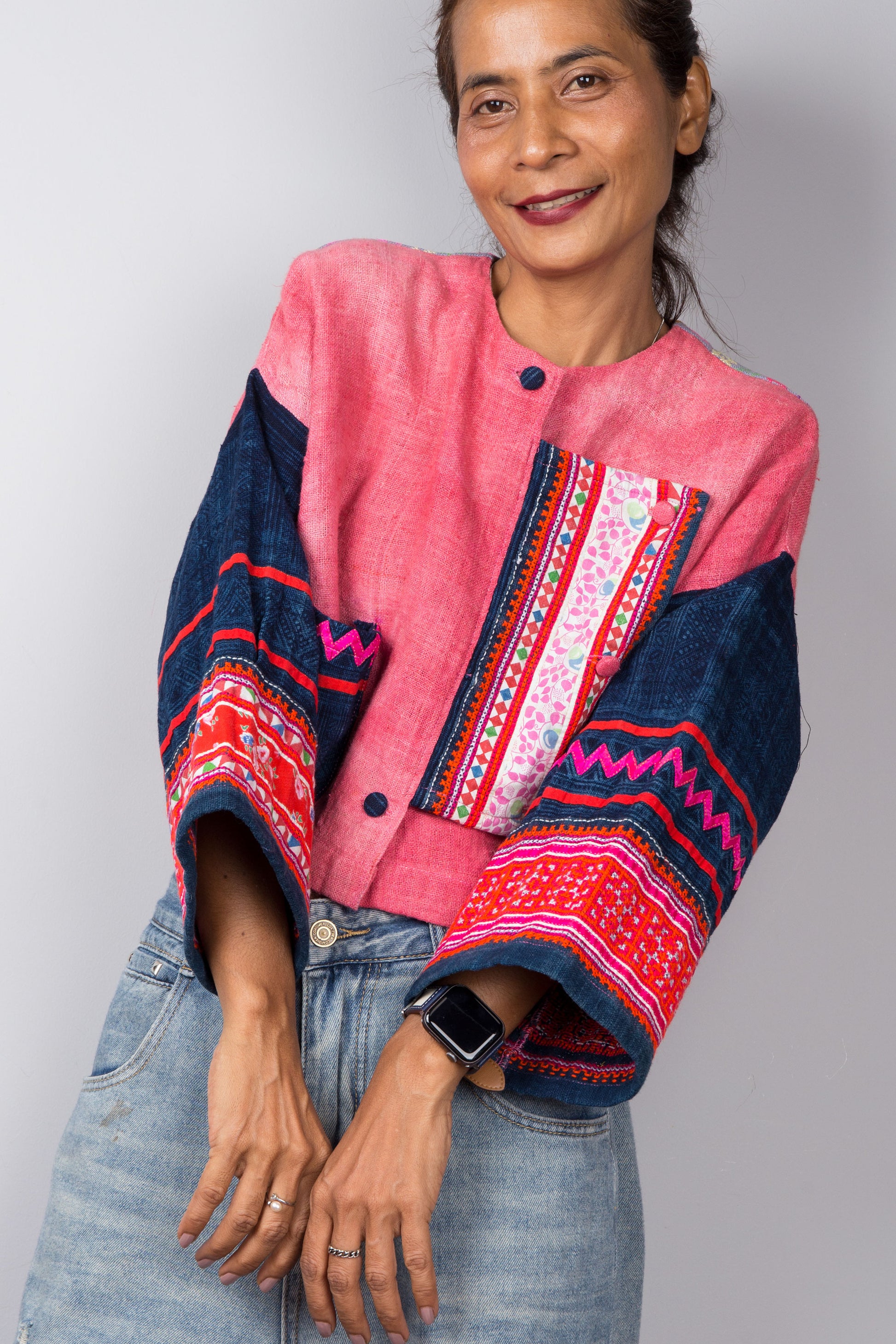Close up of the embroidered sleeves on a pink handwoven hemp jacket by Nuichan