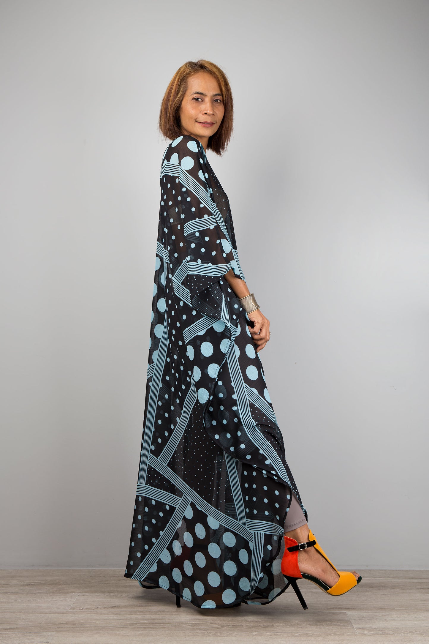 Light blue polka dot caftan dress by Nuichan.  Caftan with small v neck in a sheer chiffon fabric.