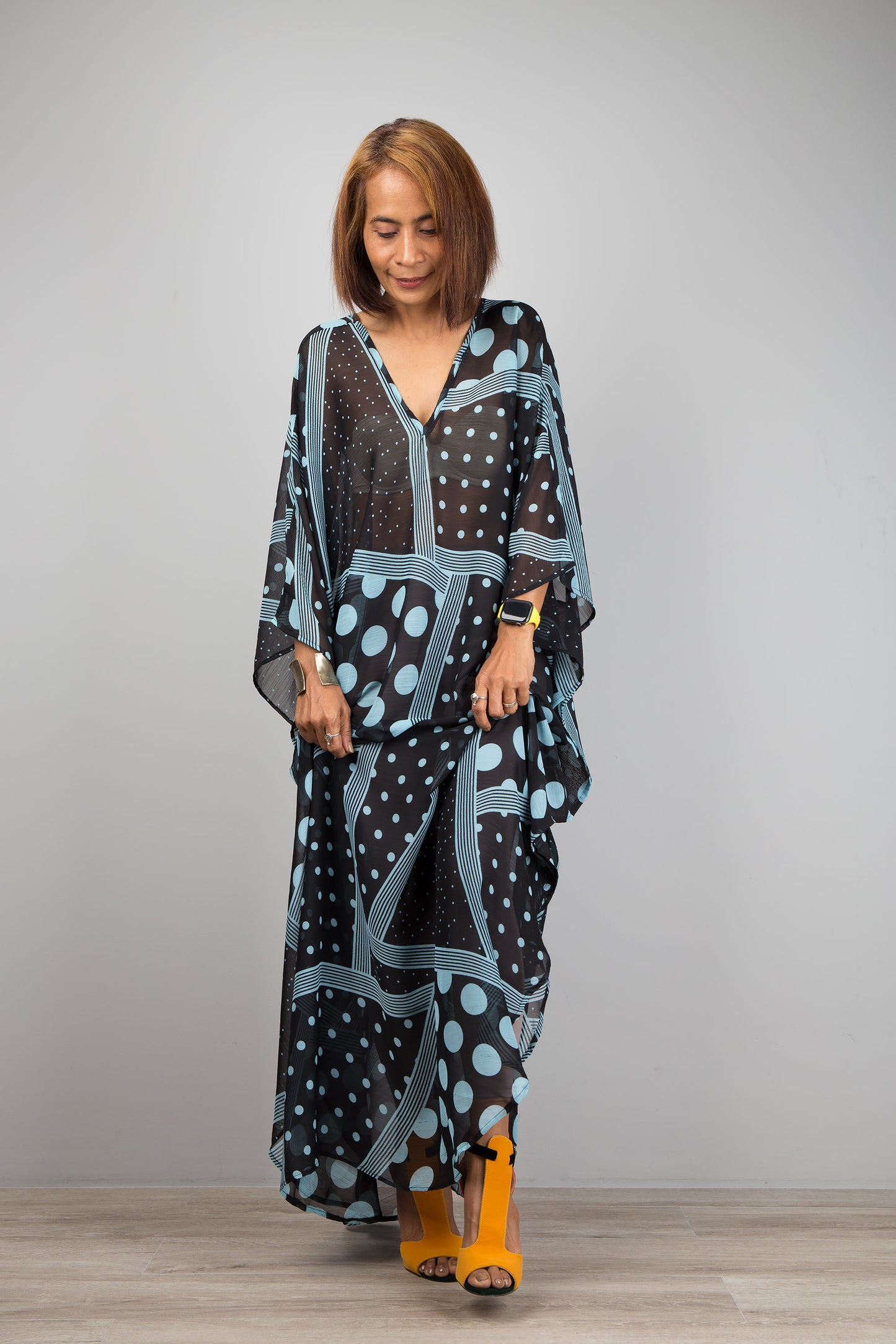 Light blue polka dot kaftan dress by Nuichan.  Caftan with subtle v neck in a sheer chiffon fabric.