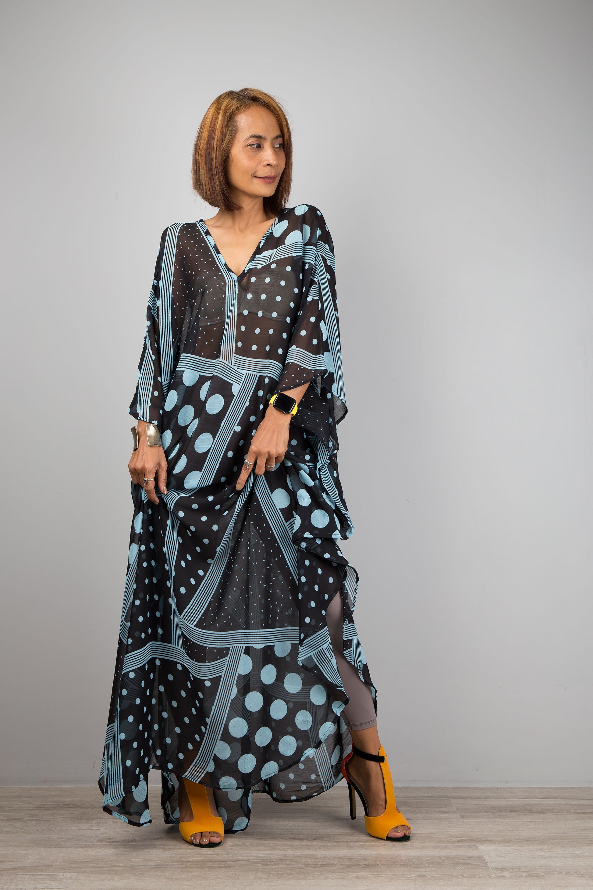 Light blue polka dot kaftan dress by Nuichan.  Caftan with small v neck in a sheer chiffon fabric. Split on the sides