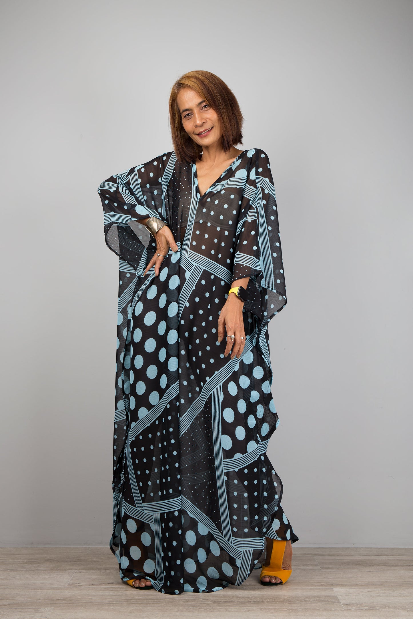 Light blue polka dot kaftan dress by Nuichan.  Caftan with small v neck in a sheer chiffon fabric. Loose fit caftan style