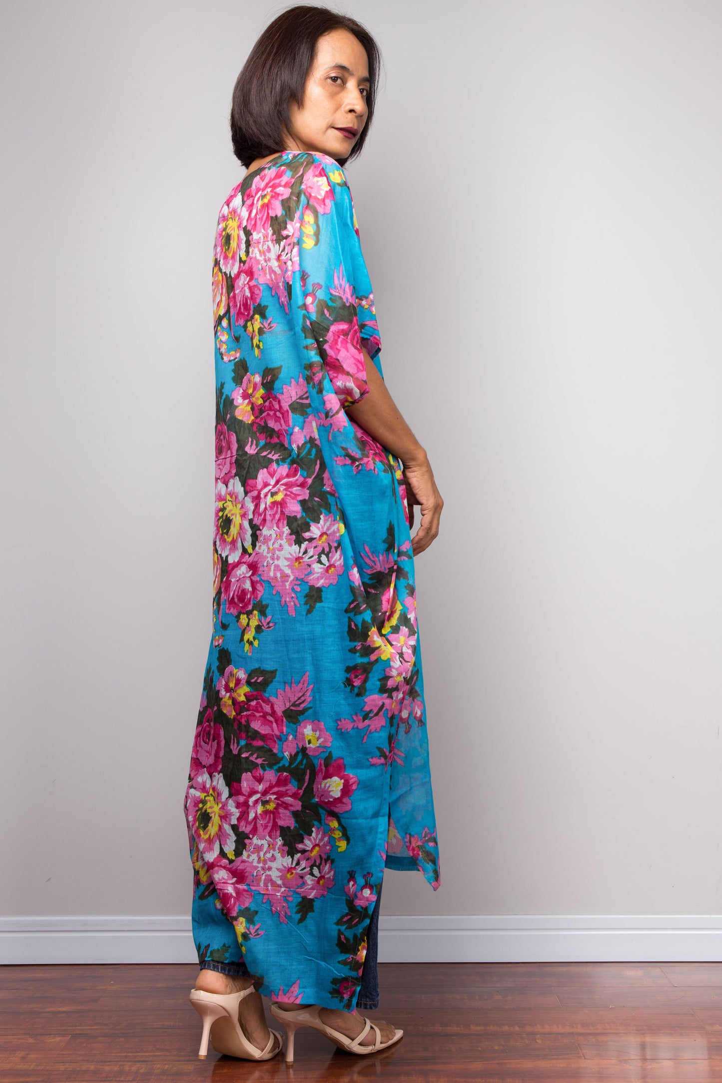 Petite Woman wearing a blue floral caftan dress against a plain background
