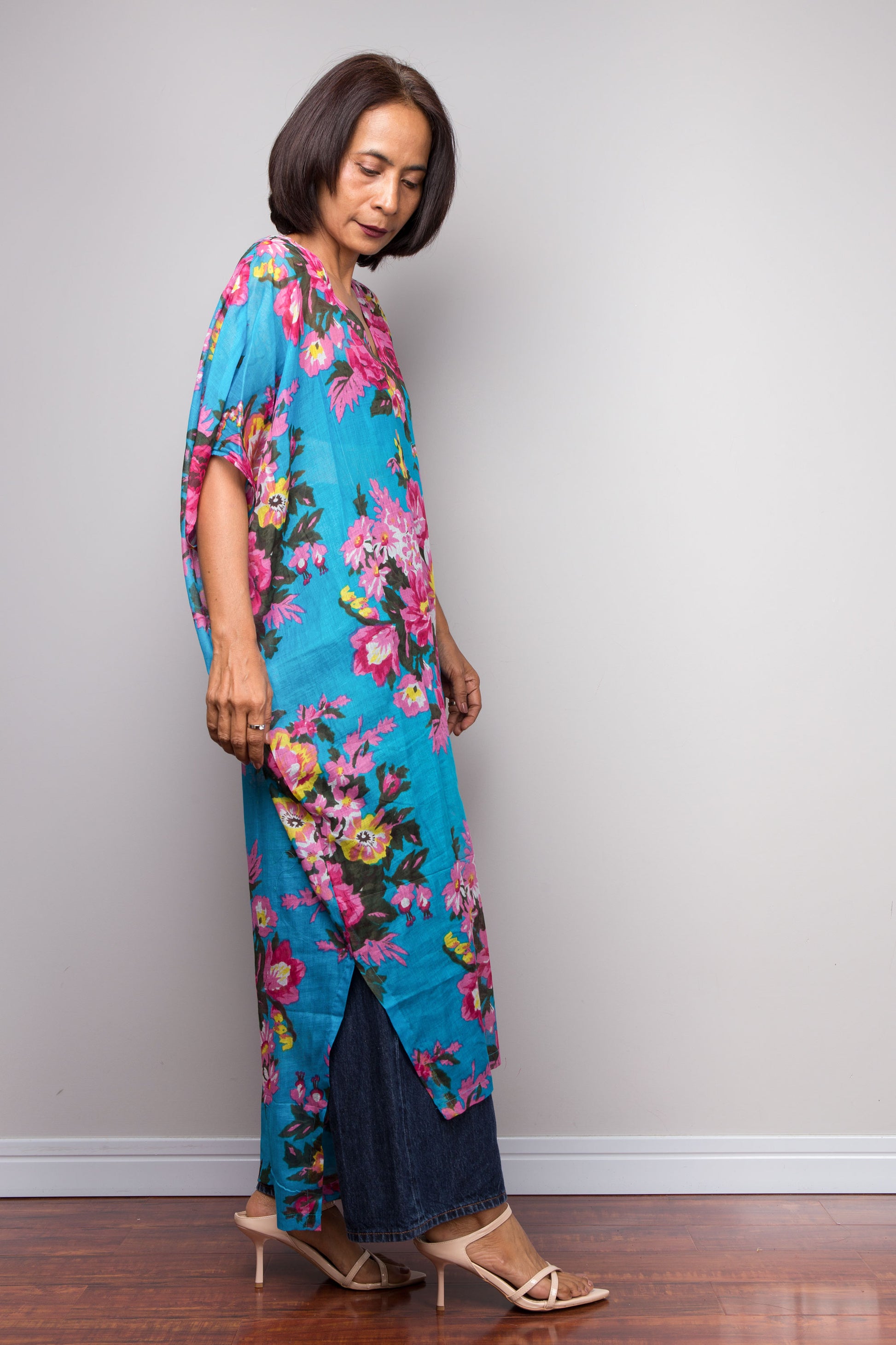 Petite Woman wearing a blue floral cotton caftan dress against a plain background