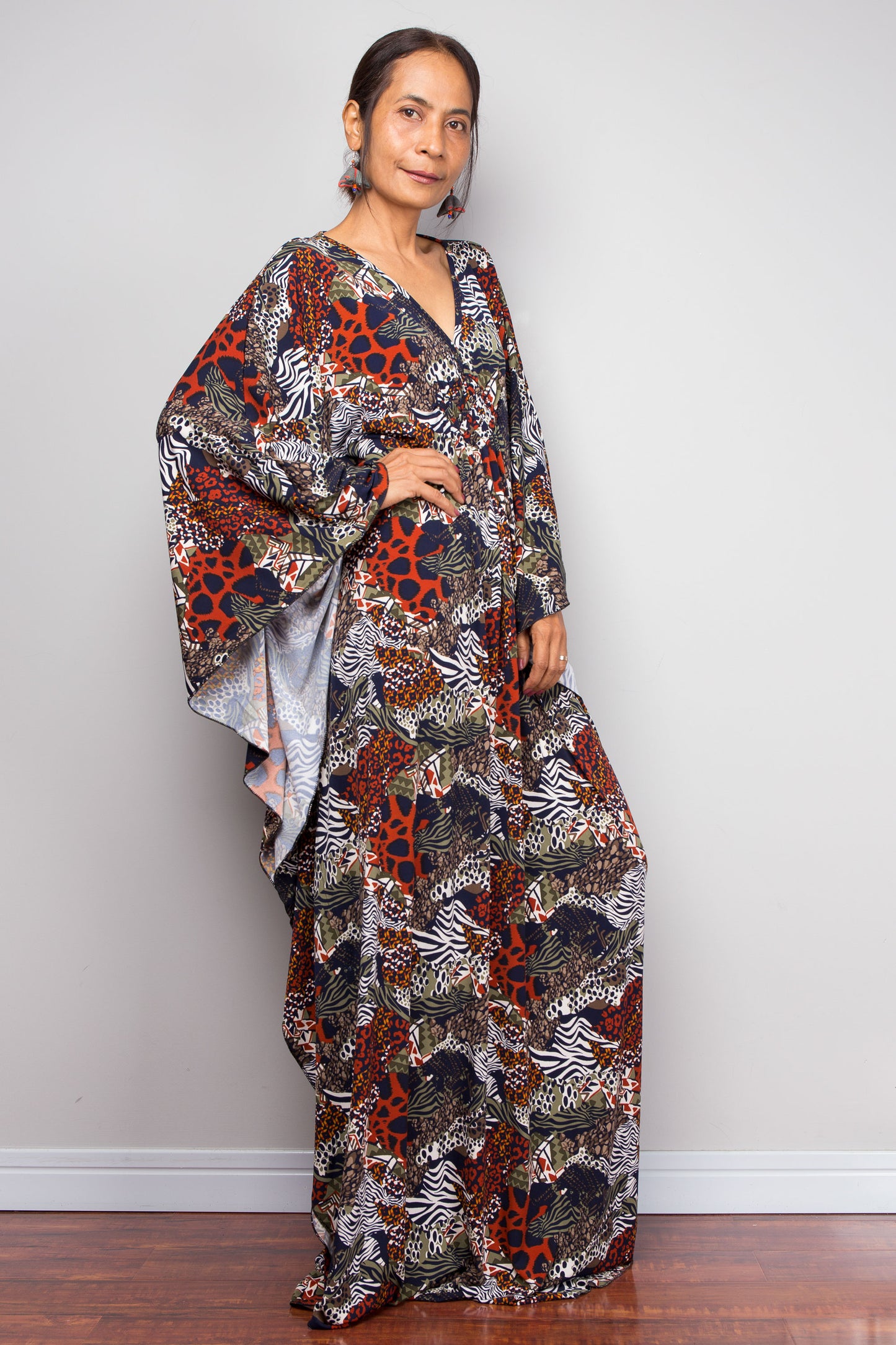 Woman wearing a patterned dress against a plain background