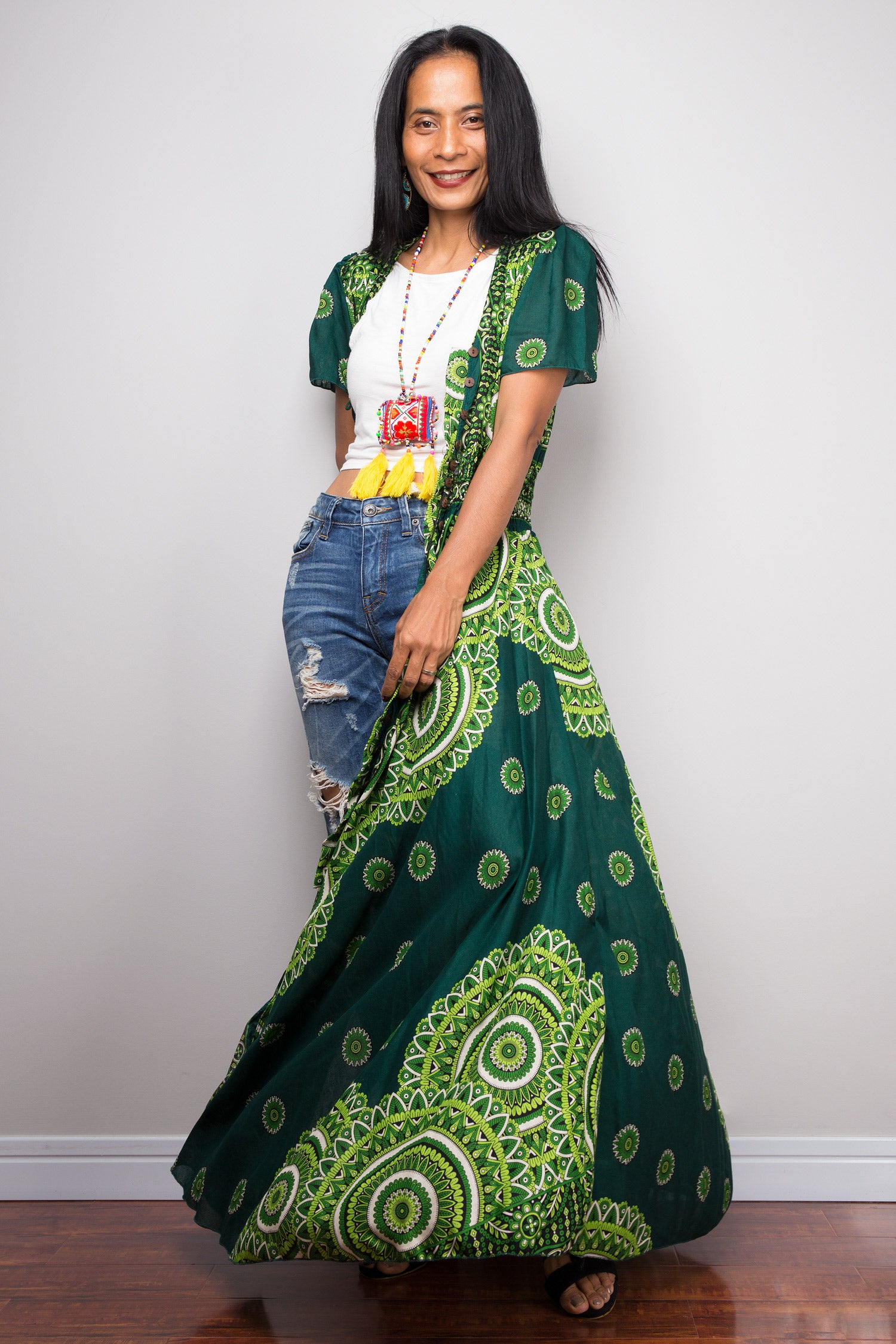Woman wearing a green and white patterned dress with a plain background.  Green duster for summer by Nuichan