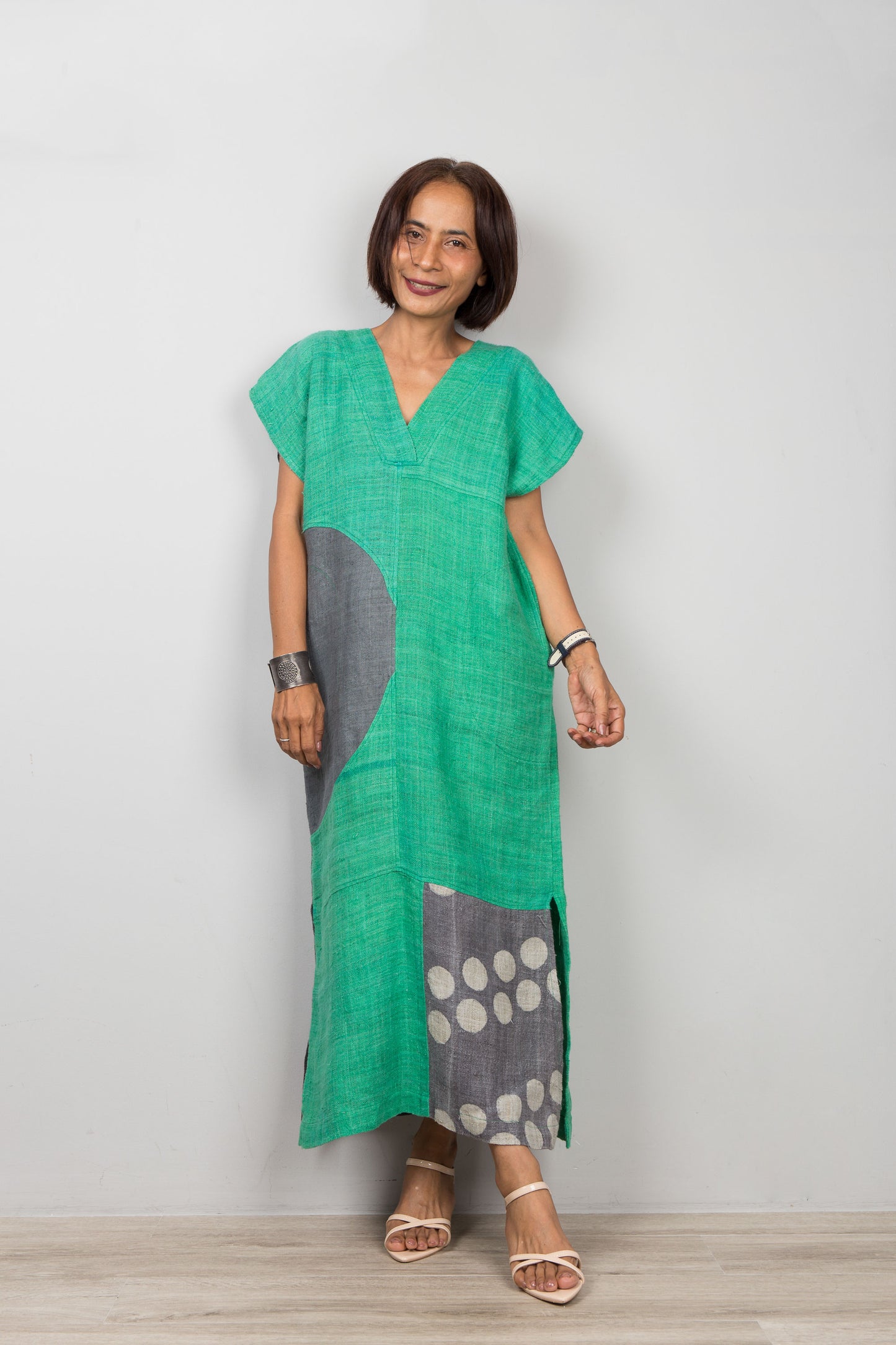 Nuichan wearing a green dress with gray and white pattern on a plain background