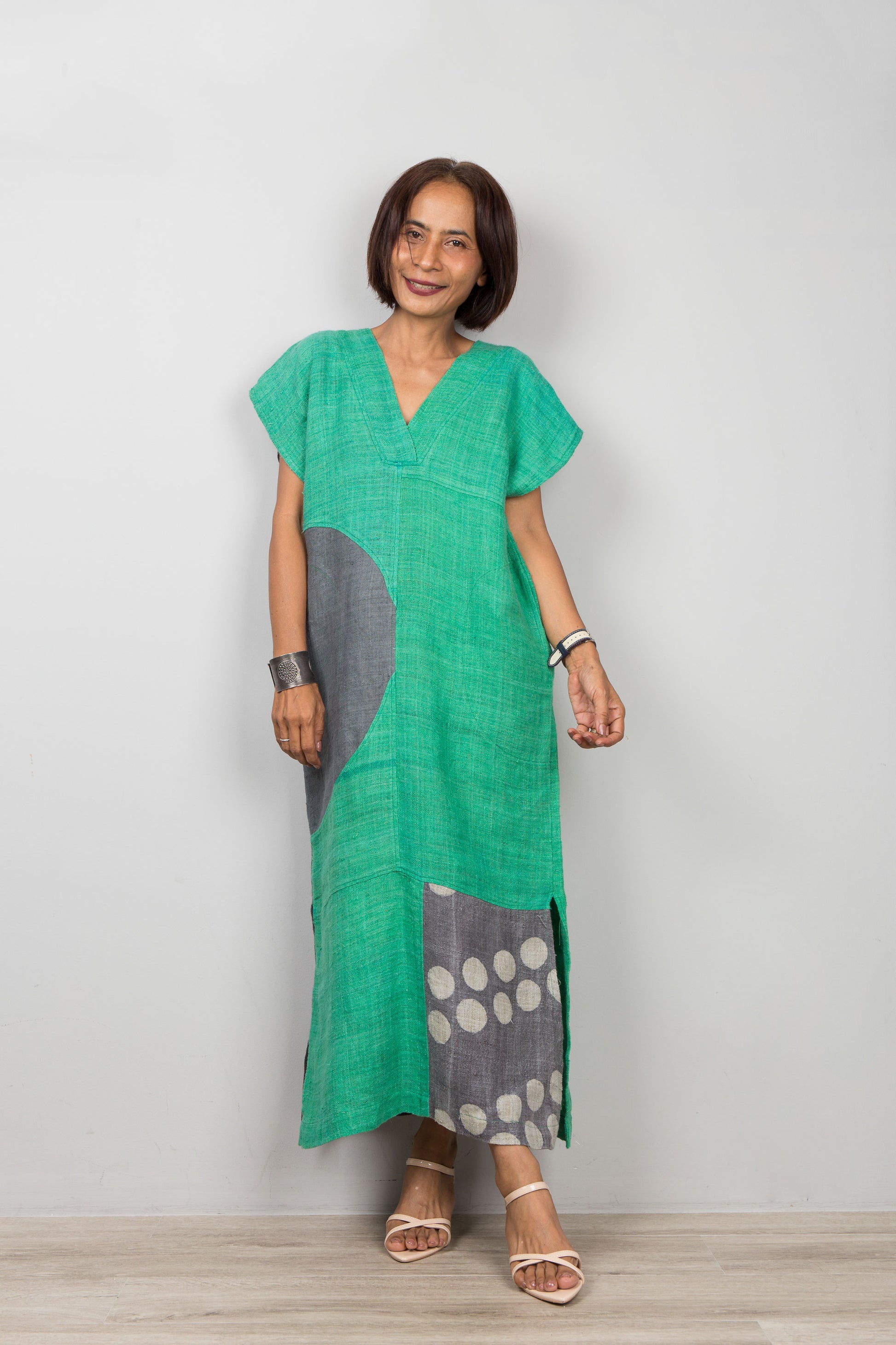 Nuichan wearing a green dress with gray and white pattern on a plain background