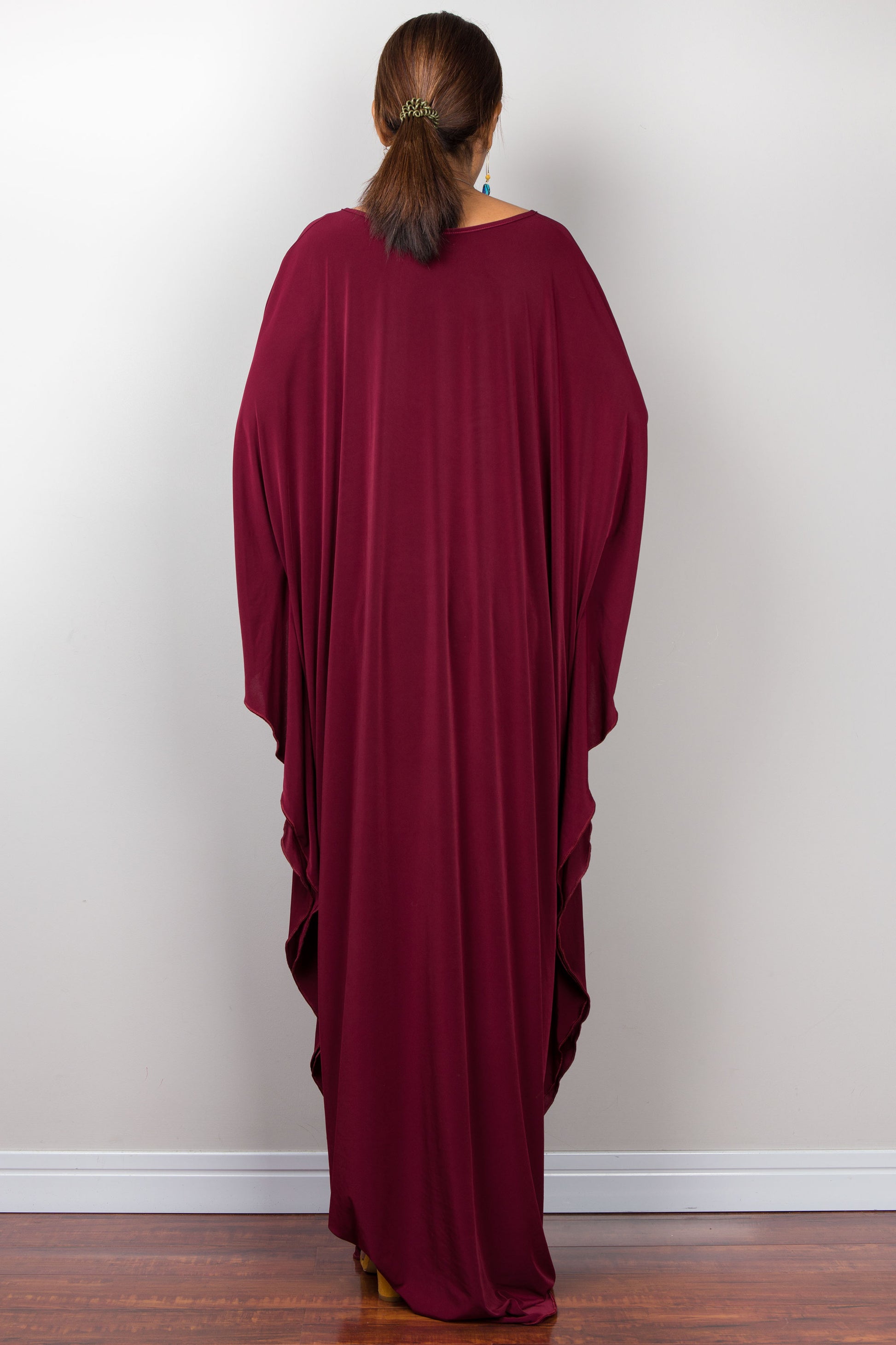 Back view of a maroon red kaftan maxi dress