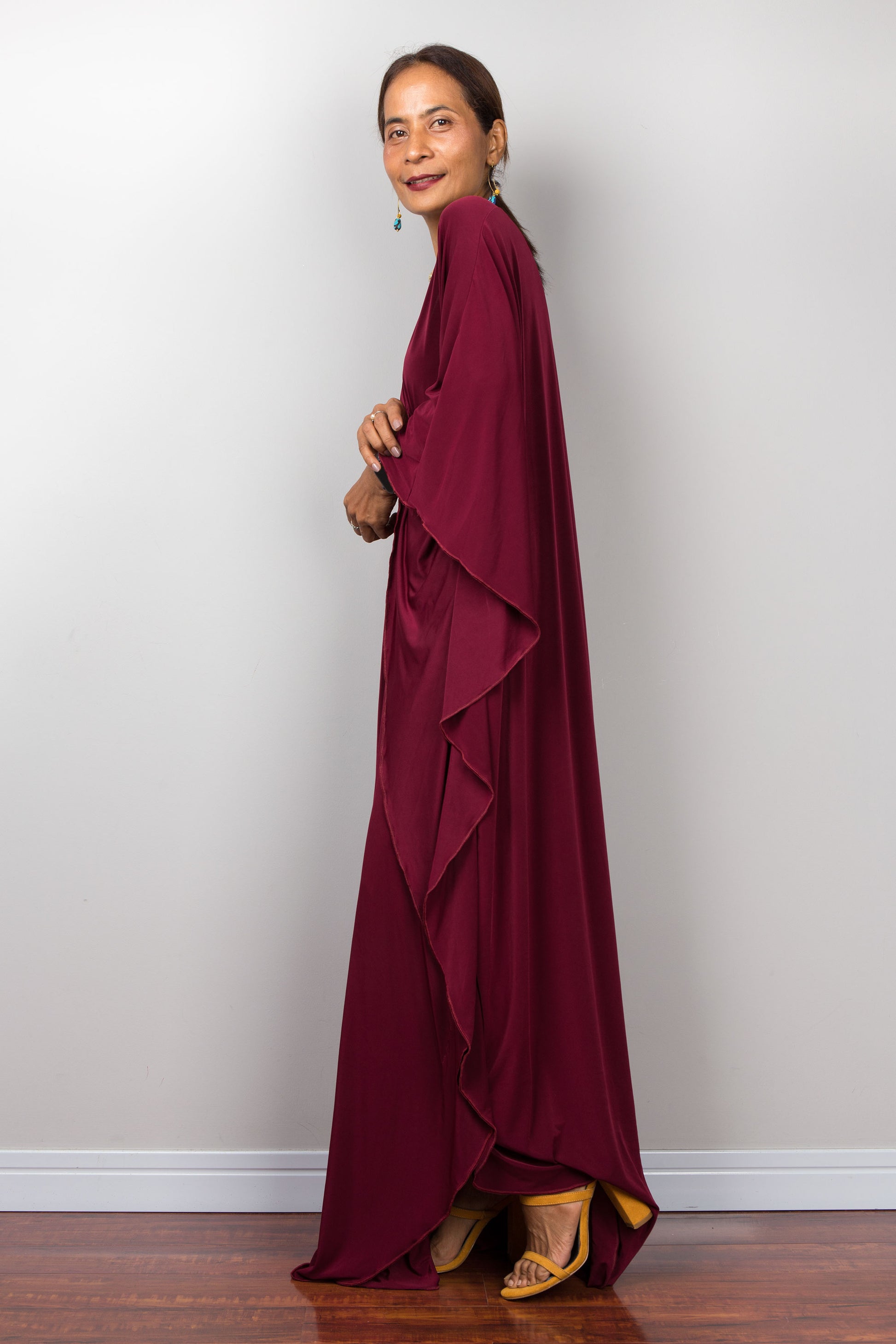 Side view of a burgundy red maxi kaftan dress