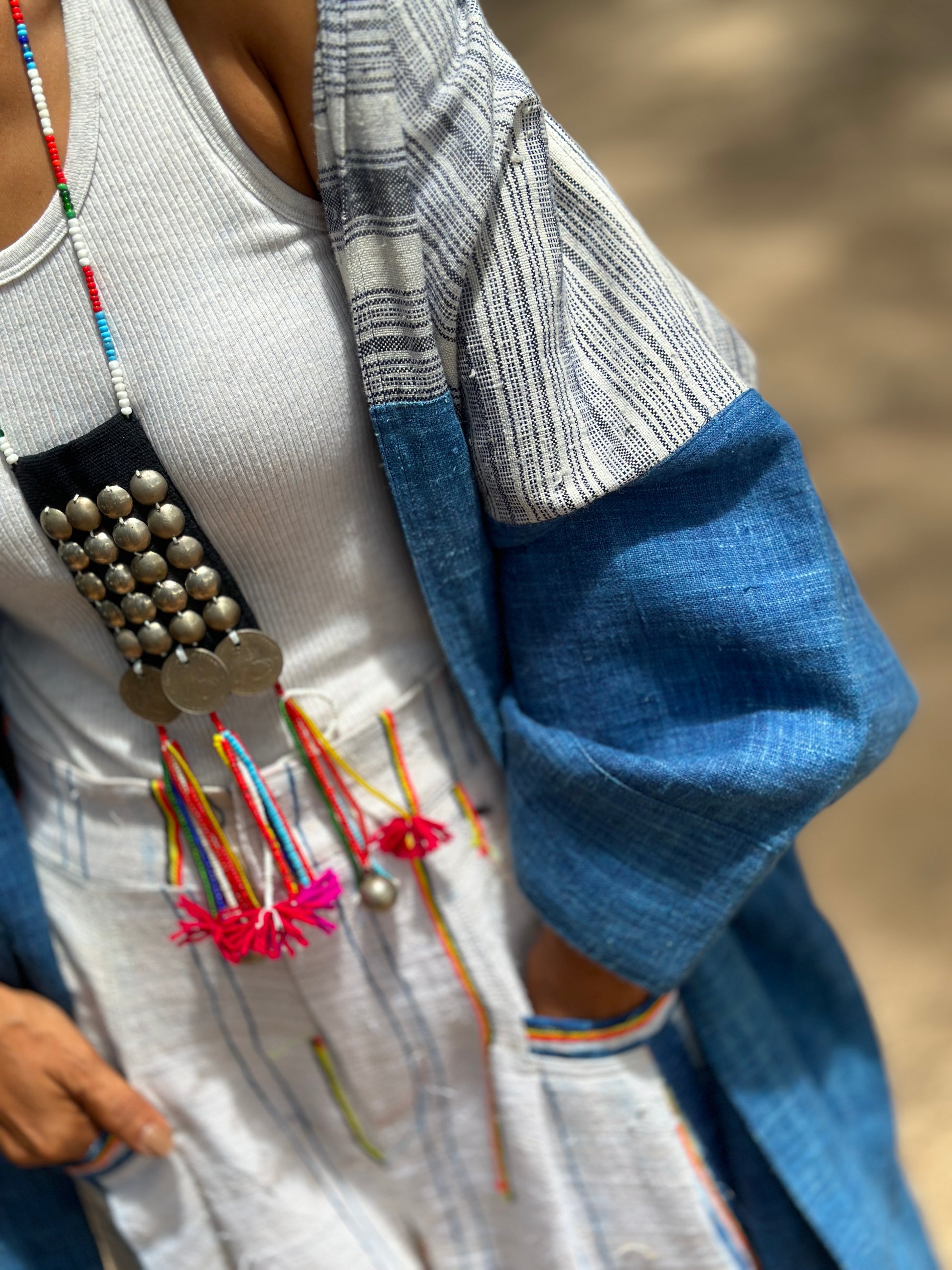Close up view of a Woman wearing natural indigo hill tribe open front cardigan outdoors at the beach,  Nuichan