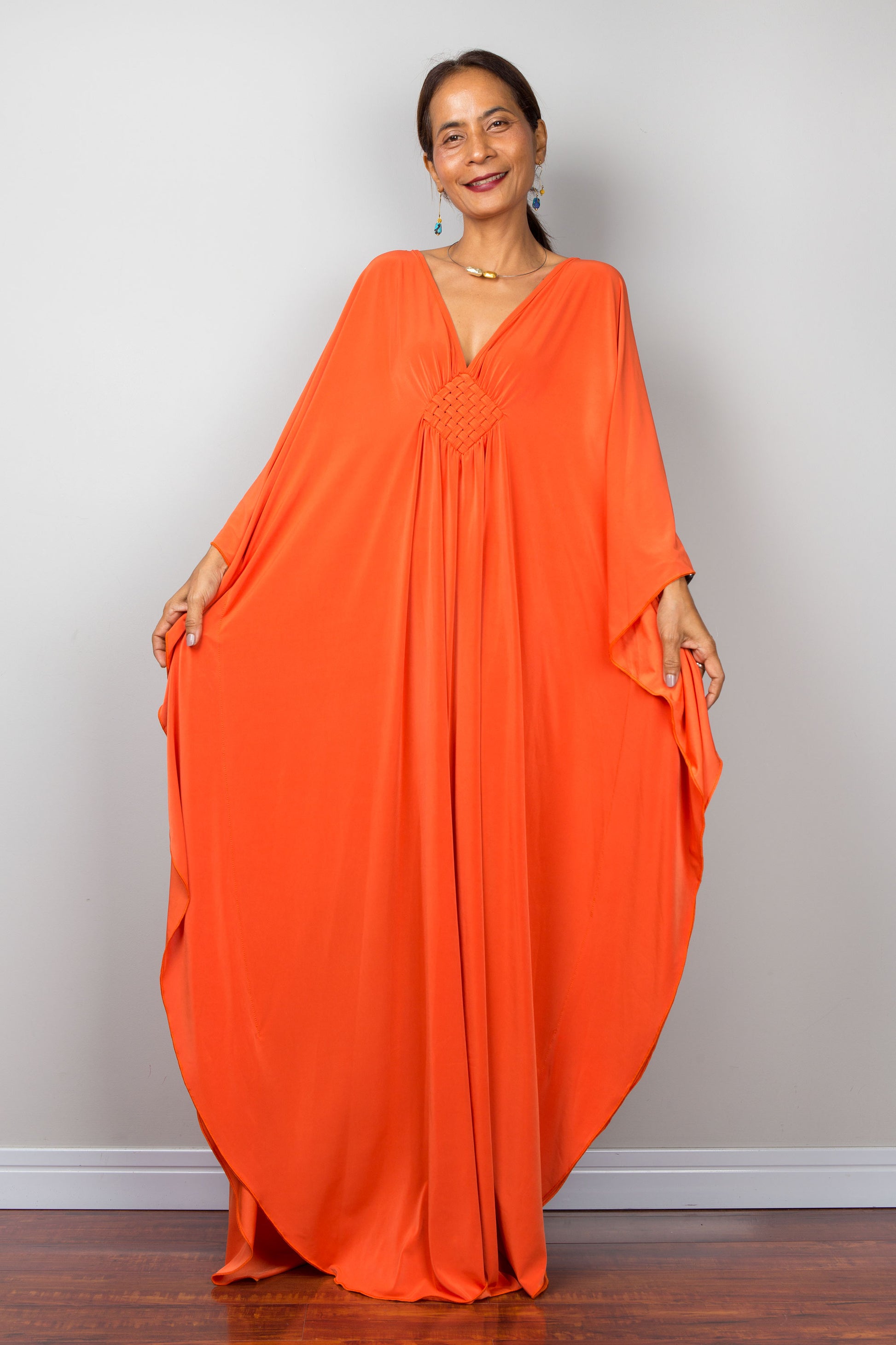 Orange kaftan dress with batwing sleeves and plunging v neckline. Design by Nuichan - front view