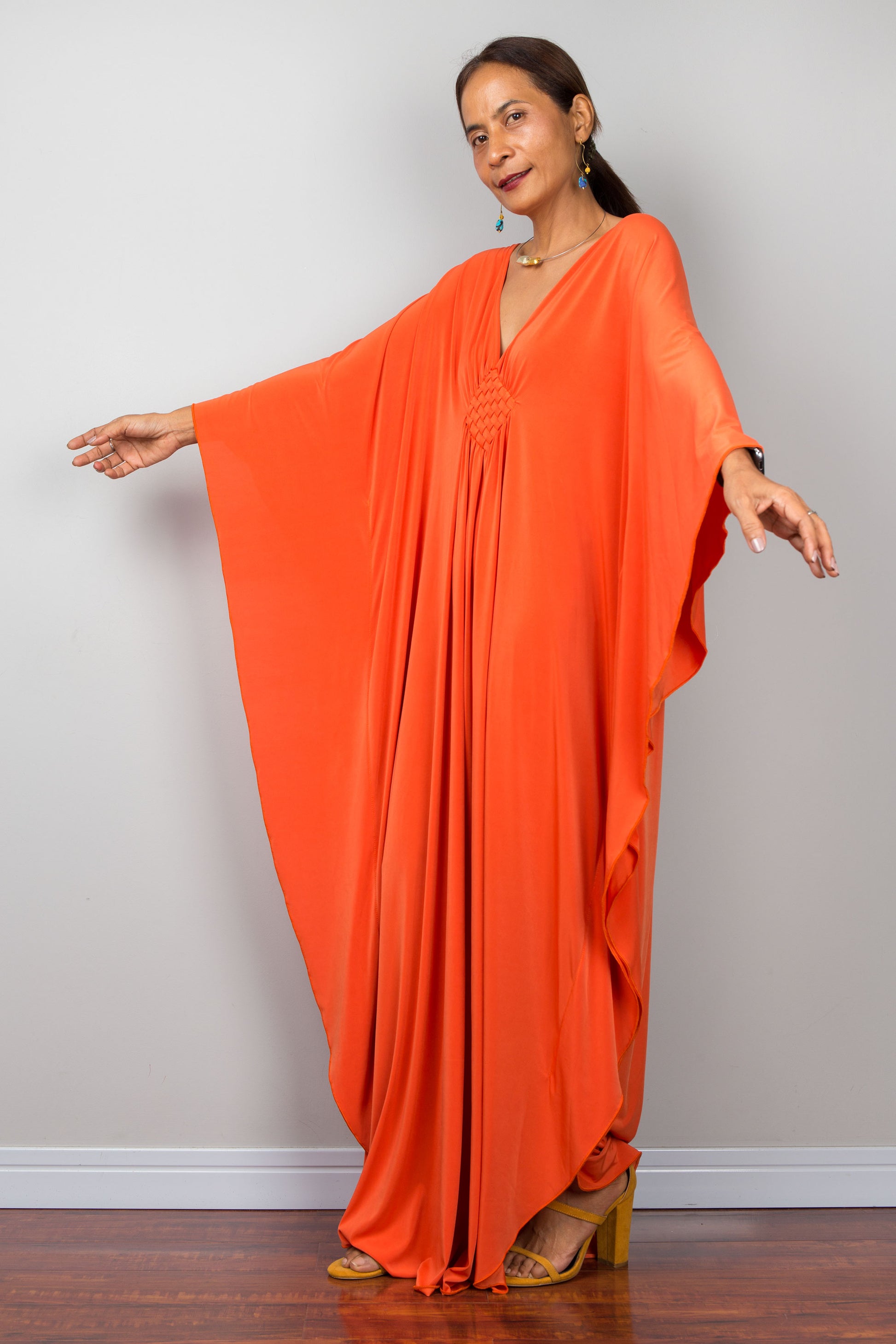 Orange kaftan dress with batwing sleeves and plunging v neckline. Design by Nuichan