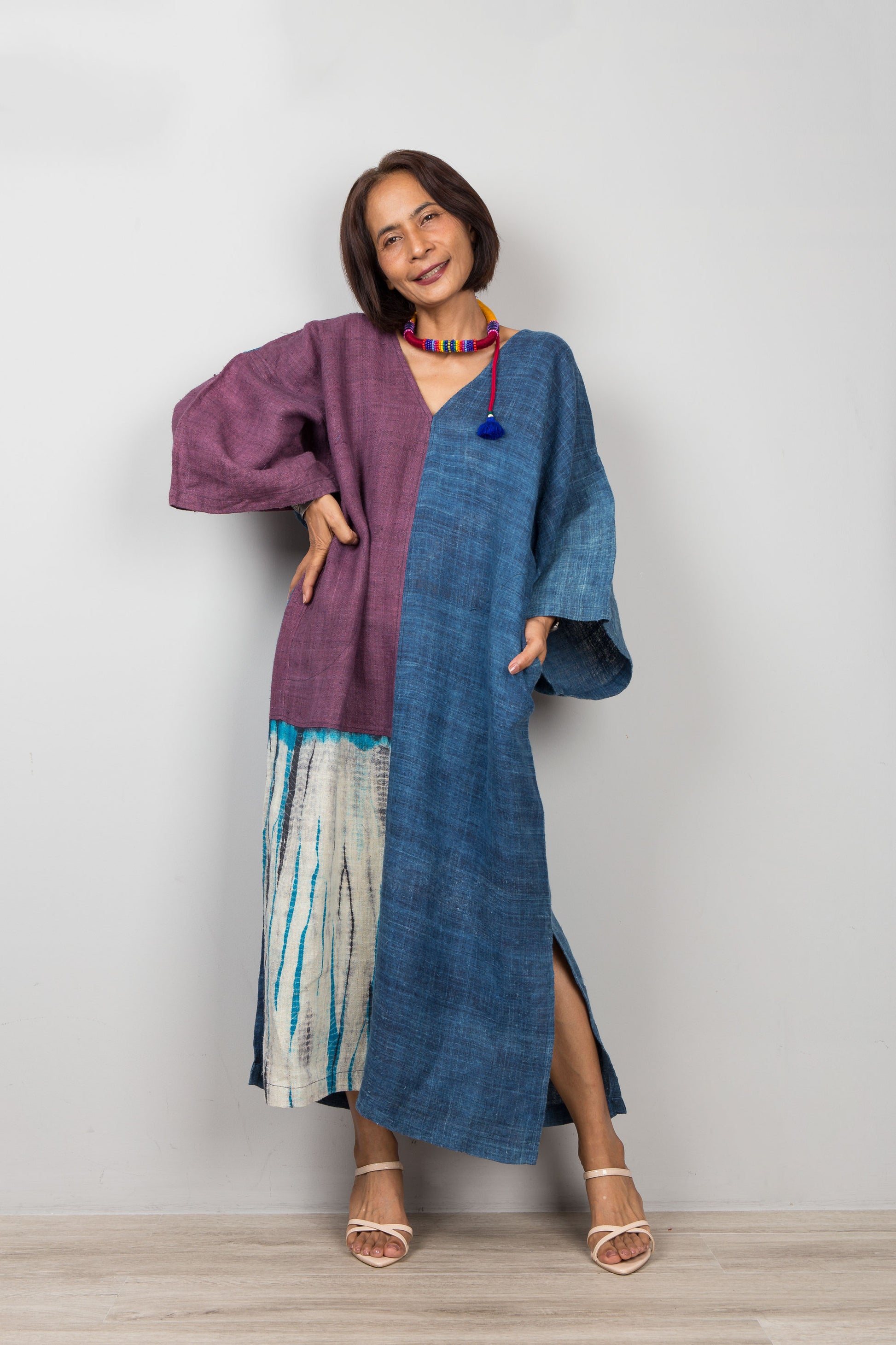 Front view of handmade indigo hemp caftan dress showing purple and shibori tie-dye patchwork panels