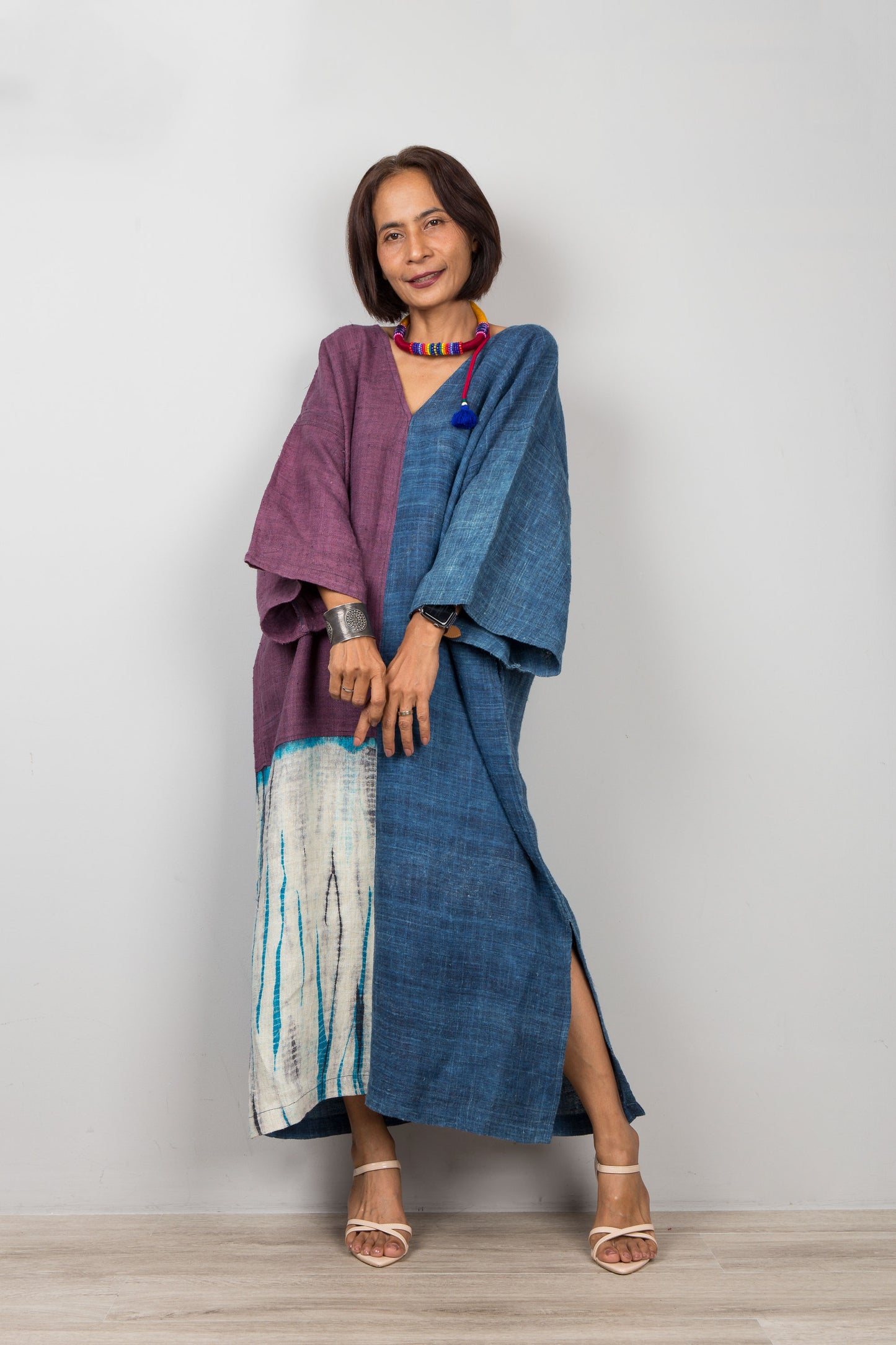Woman wearing a blue and purple outfit with a white background