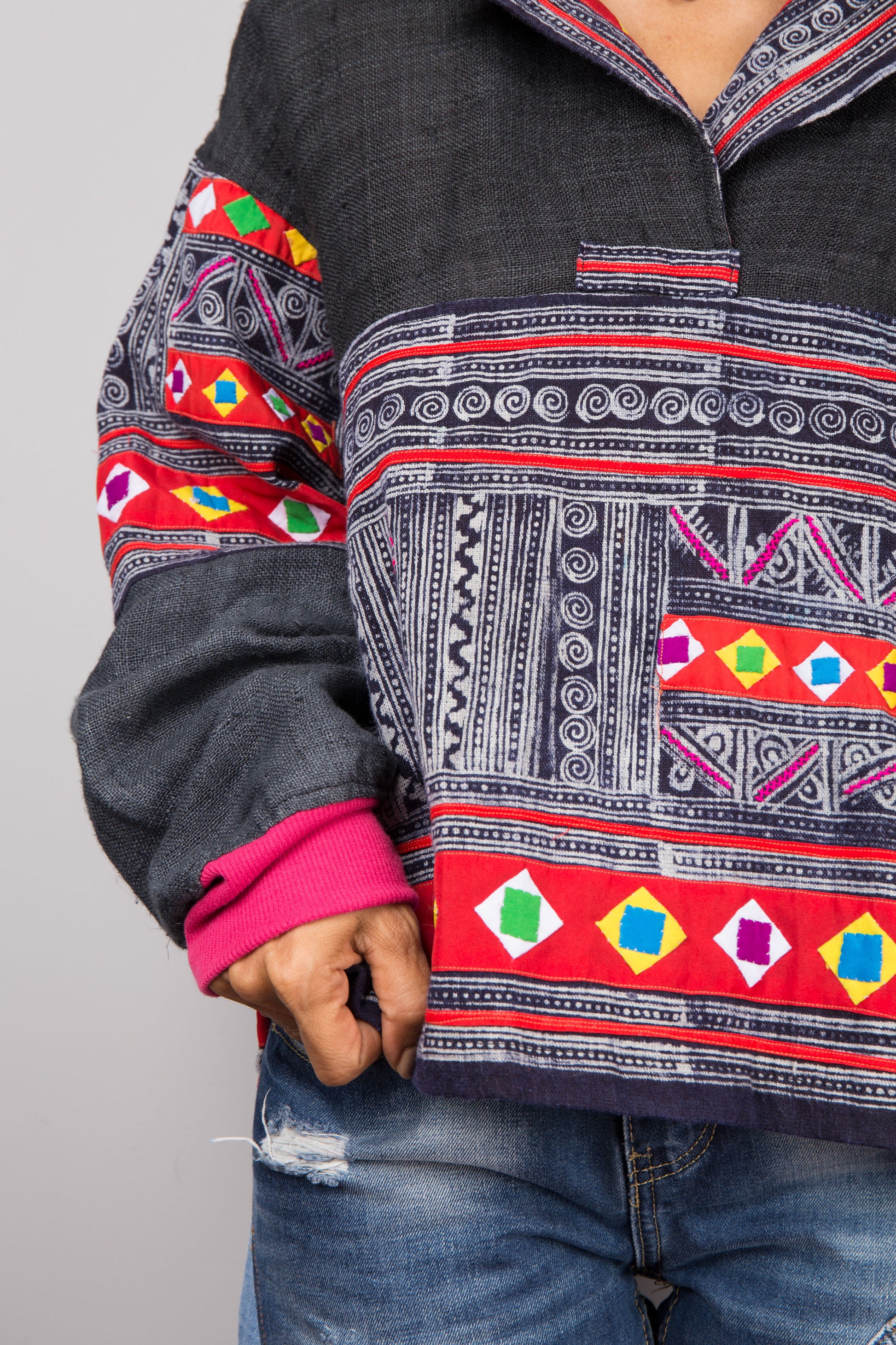 Woman wearing a hand-batik pullover tunic with patchwork designs by Nuichan, 
