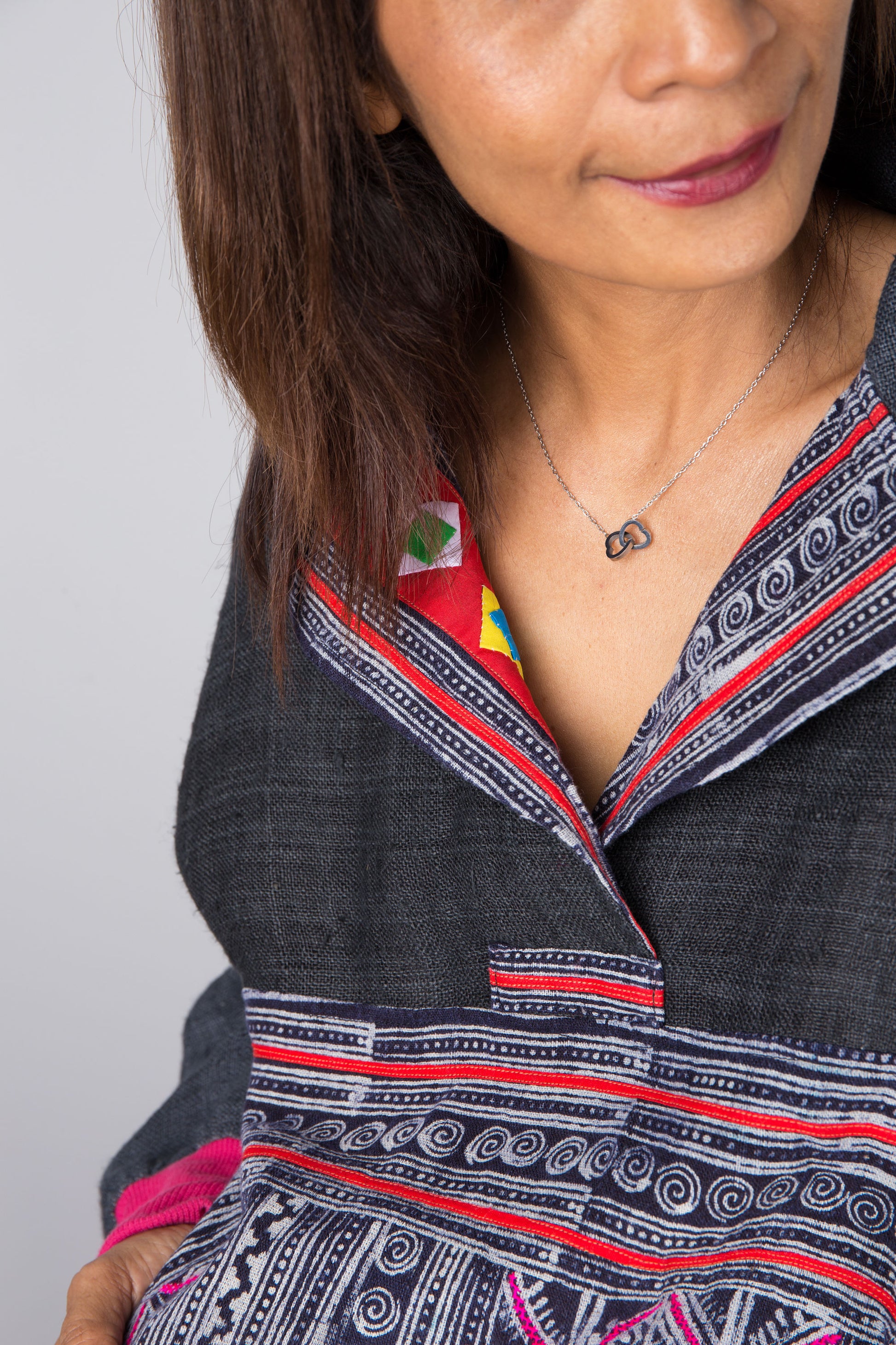 Nuichan hand-batik pullover tunic with long sleeves and patchwork accents on a woman

