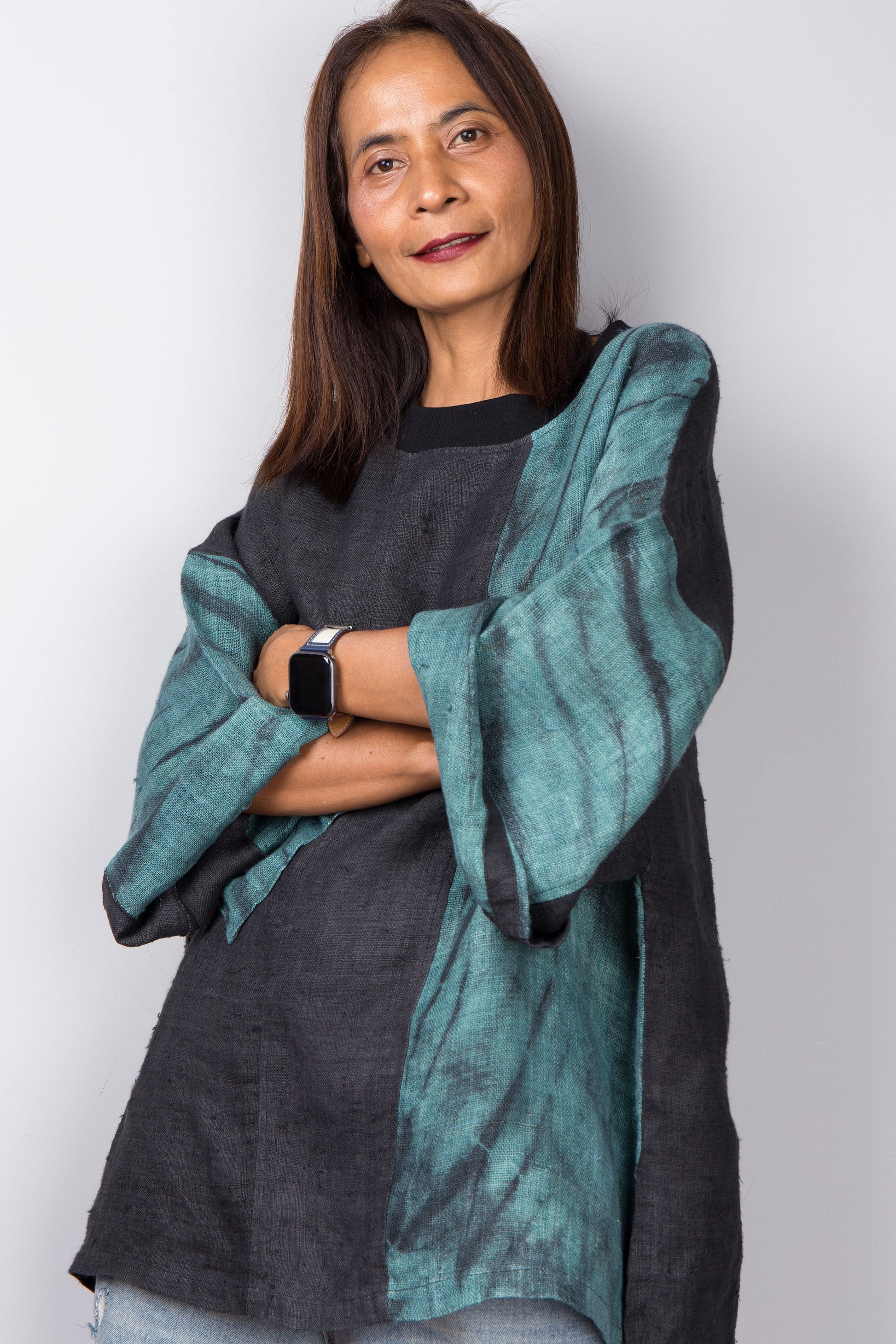 Two tone oversized shirt with big front pocket. Black and green tones with shibori tie dye detail. Rolled up sleeve view