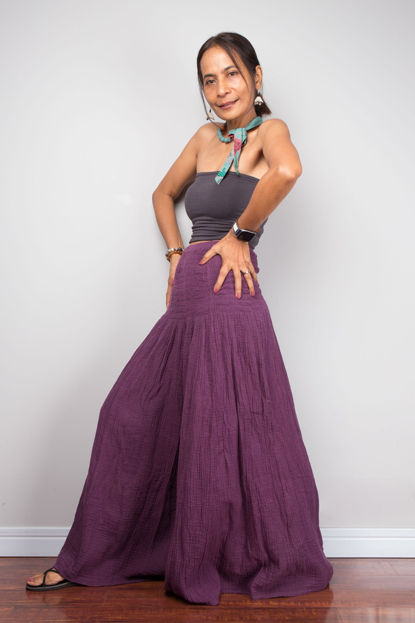 Woman wearing purple wide leg cotton pants against a white background