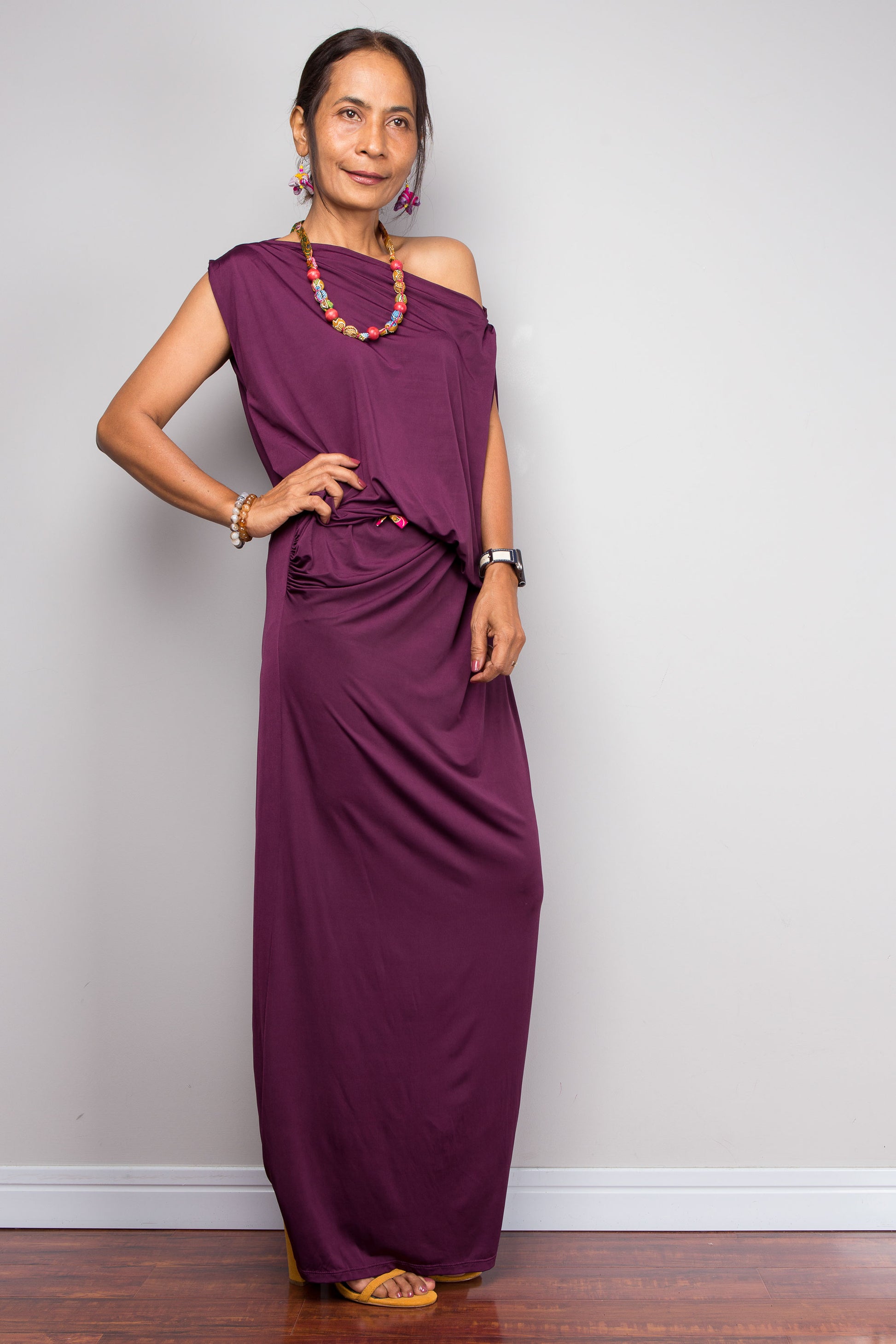 Woman wearing a purple dress against a plain background
