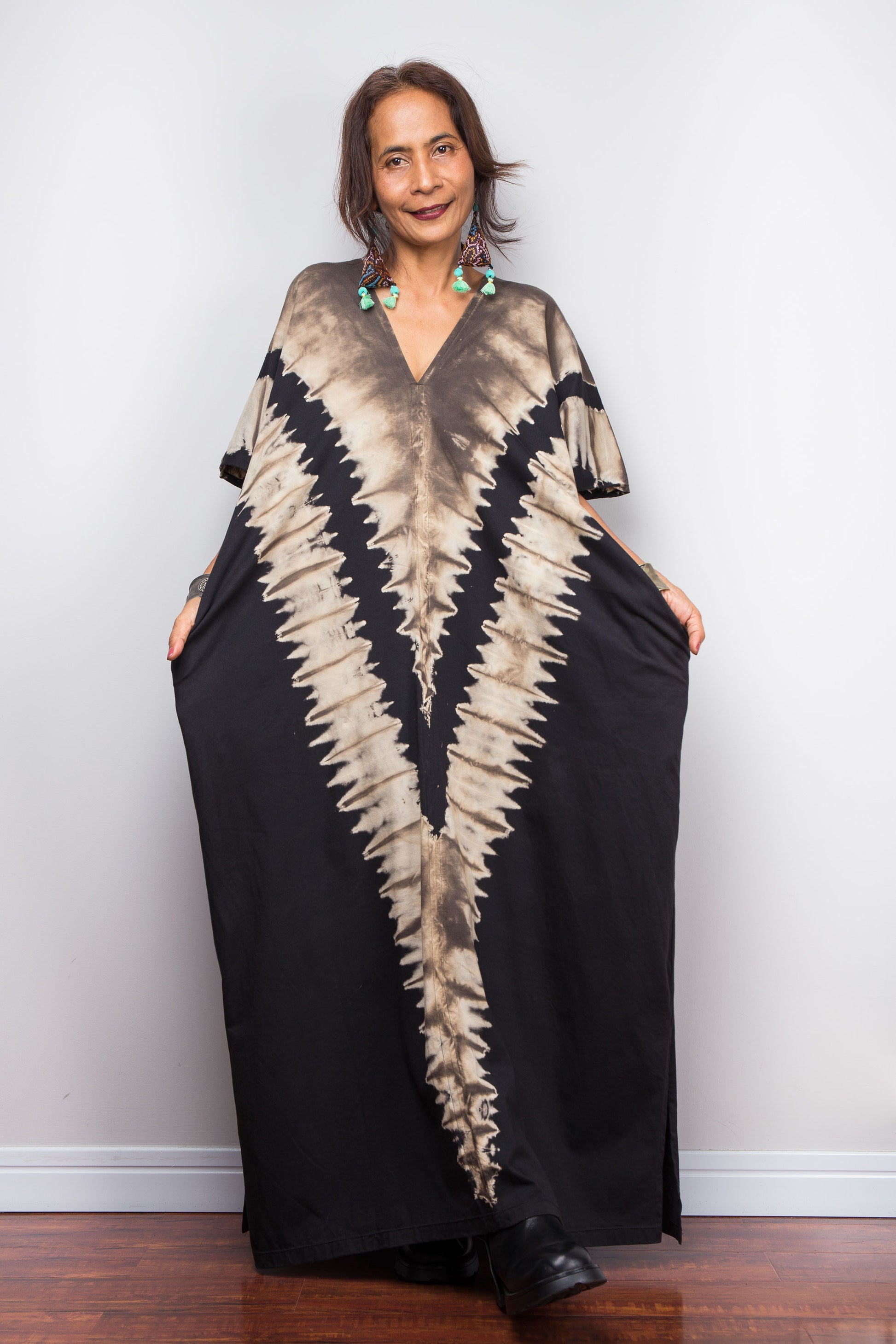 Authentic Nuichan brand oversized black and sand reverse tie dye dress, a cotton boho maxi dress with short sleeves and pockets worn by a petite model.