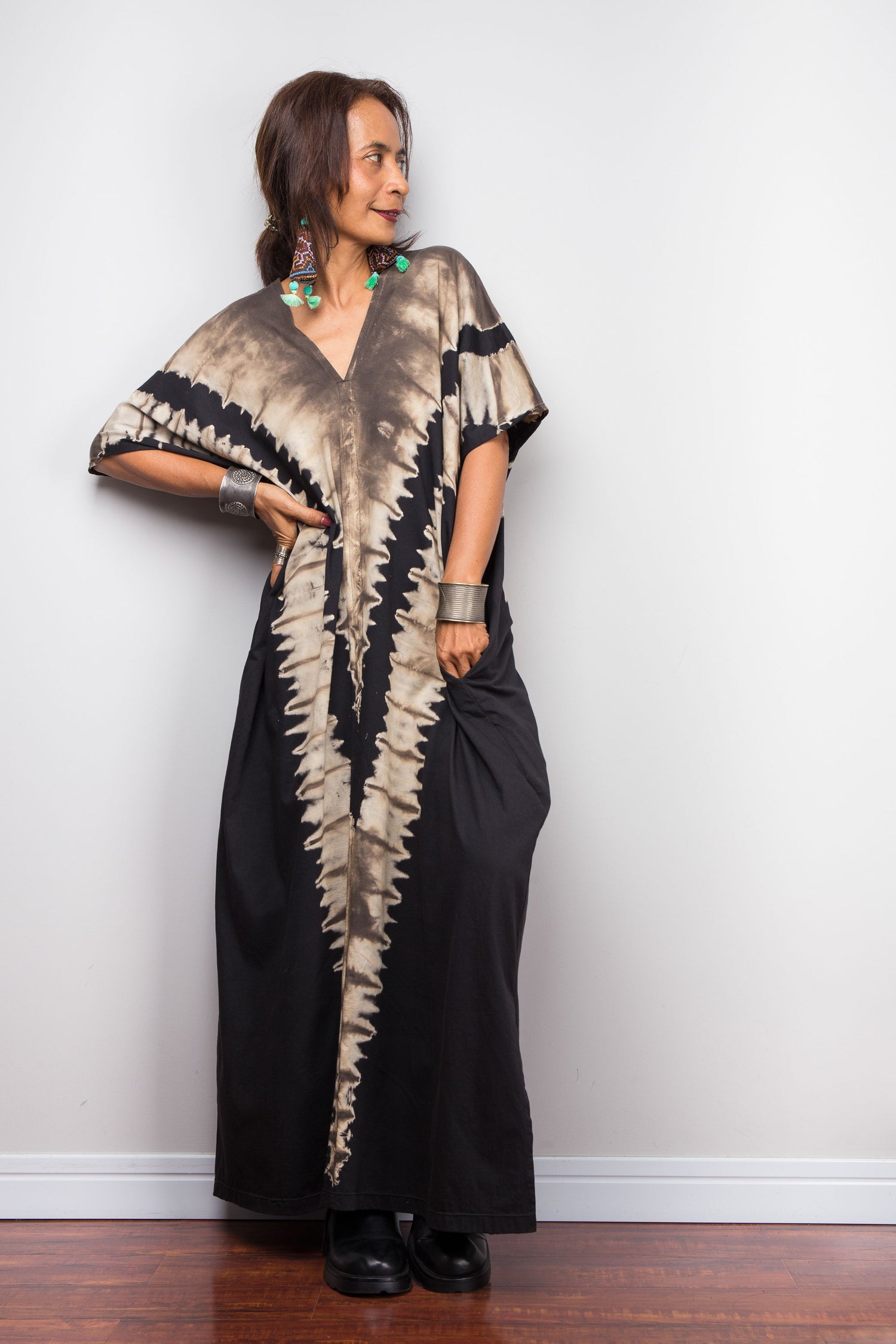 Authentic Nuichan brand oversized black and sand reverse tie dye kaftan dress, a cotton boho maxi dress with short sleeves and pockets worn by a petite model. standing agains a white background