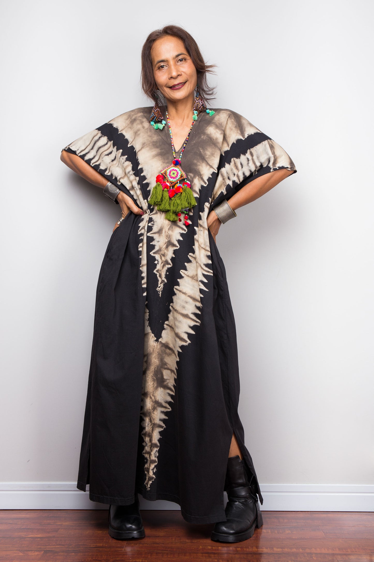 Authentic Nuichan brand oversized black and sand reverse tie dye kaftan dress, a cotton boho maxi dress with short sleeves and pockets worn by a petite model, facing forward