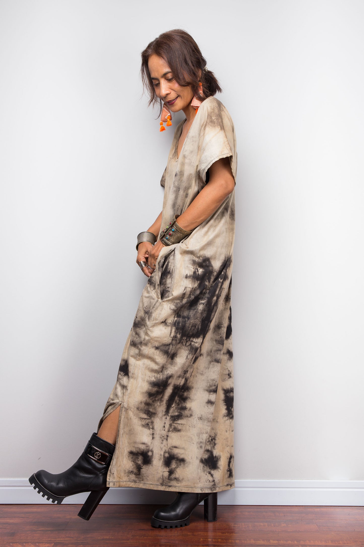 Side view of a model showcasing a light sand-toned variant of Nuichan's oversized cotton kaftan gown, highlighting the subtle V-neck shape, short kaftan sleeves, and organic, smoke-like reverse bleach-dye patterns.